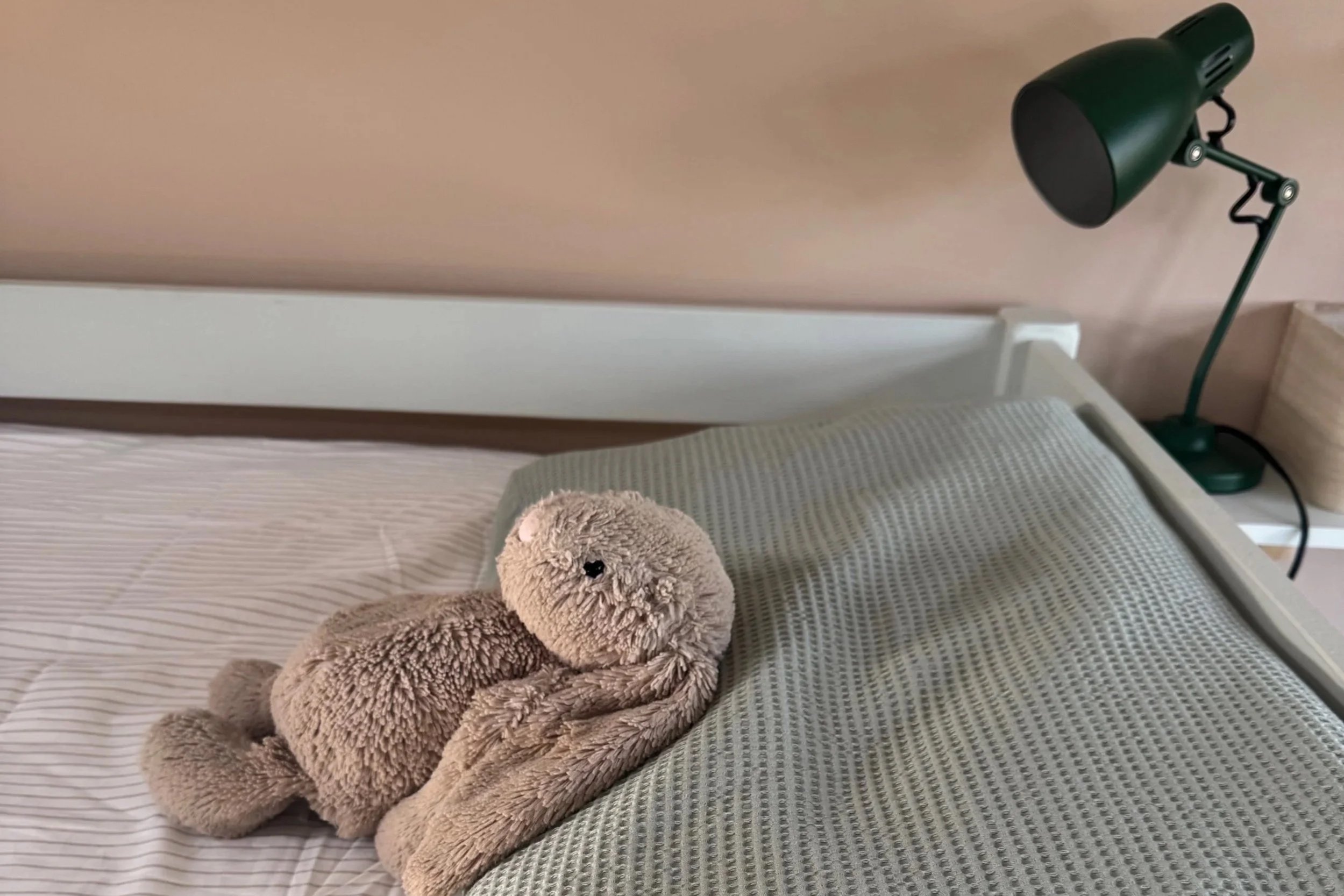 Soft toy rabbit on bed