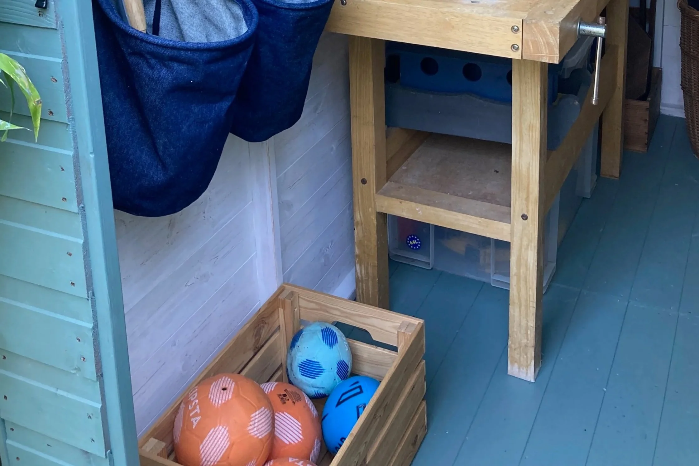 Wooden crate of footballs on the floor