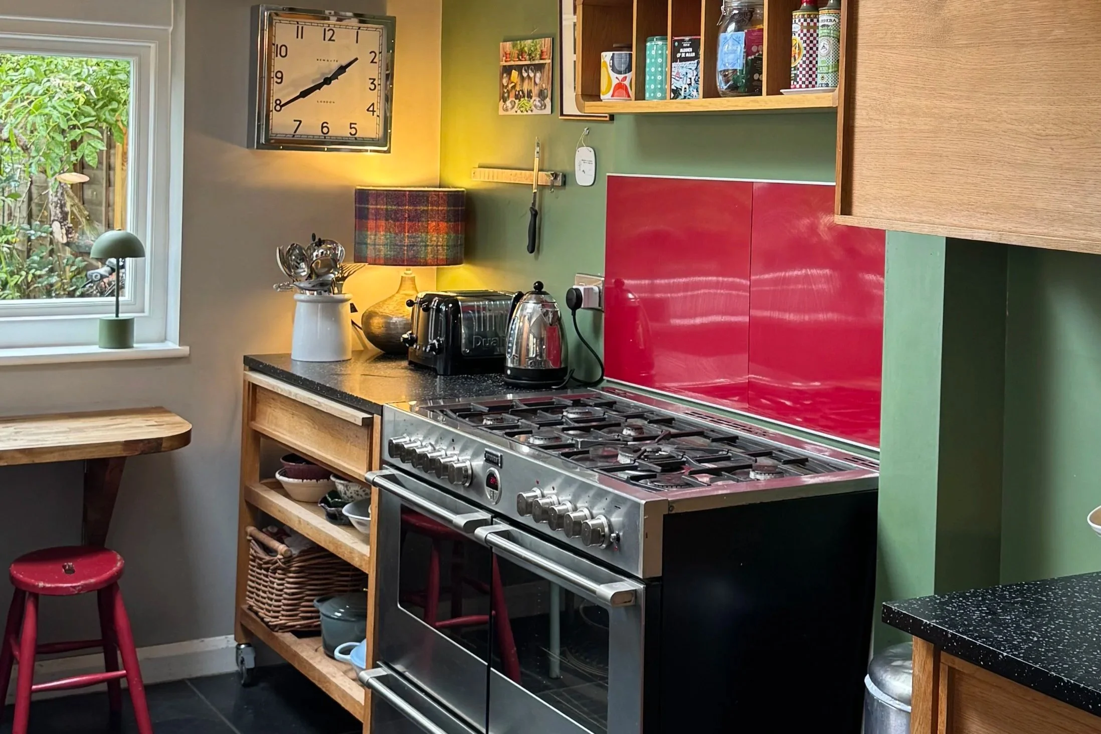 View of kitchen with green walls and red highlights