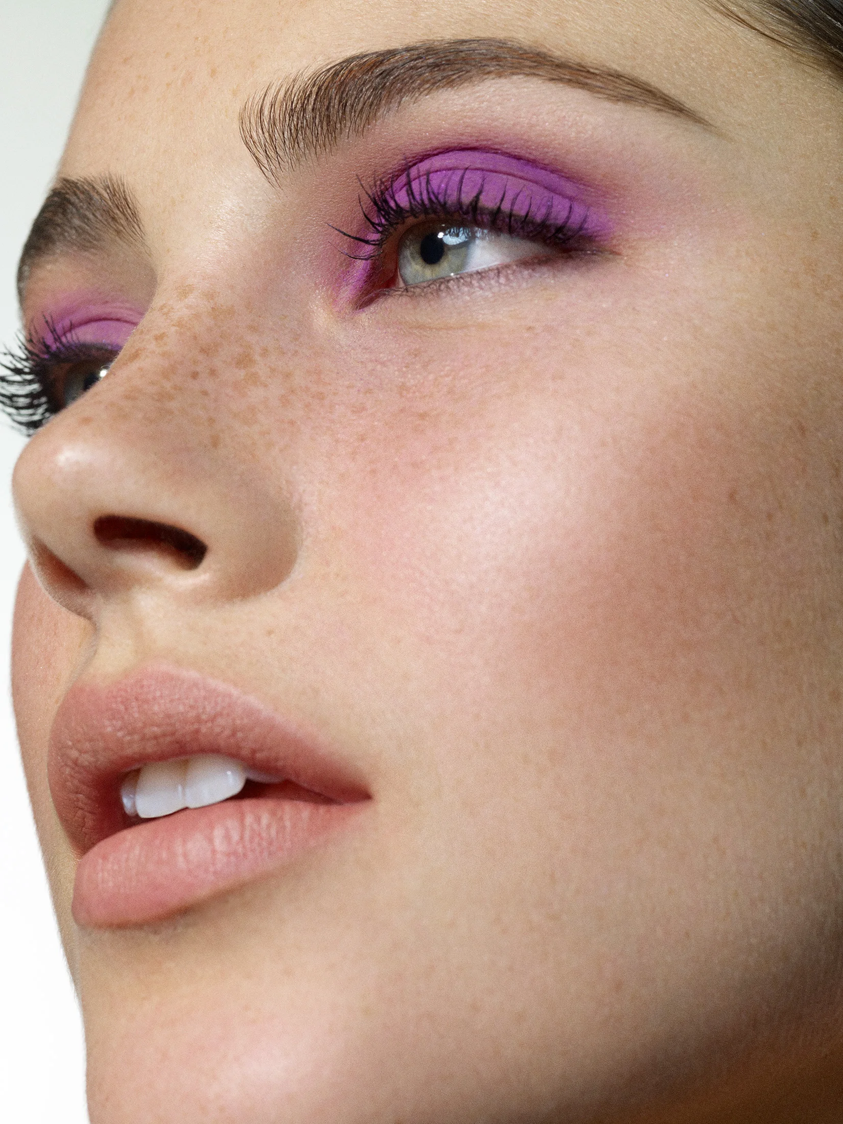 advertising beauty portrait featuring neon purple eye shadow