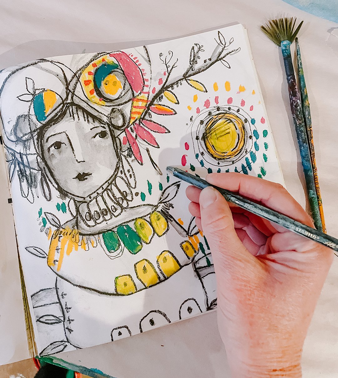 A coloring book page from " The Big Monster" by Juliette Crane with a hand holding a pencil.