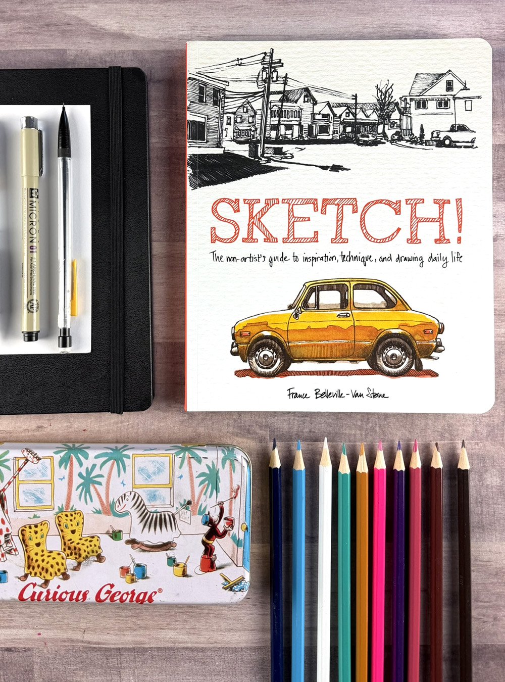 Copy of the book, "Sketch!" by France Belleville - Van Stone with a sketchbook, colored pencils, pens and a pencil box.