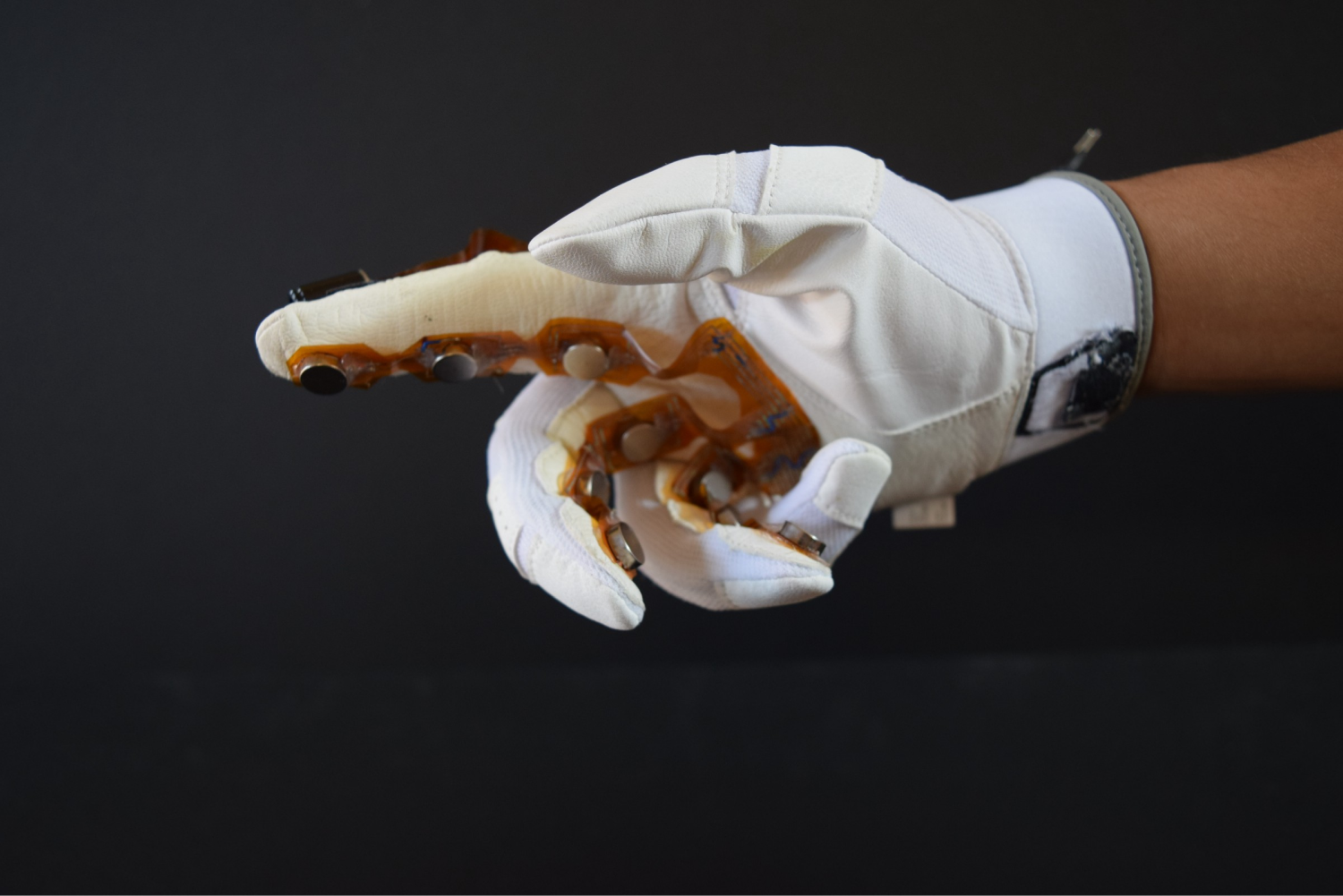  We attached vibration motors to the underside of the glove. These motors allowed the user to “feel” the temperature input from the infrared thermometer positioned at the tip of the index finger. This could be used for professionals that work in extr