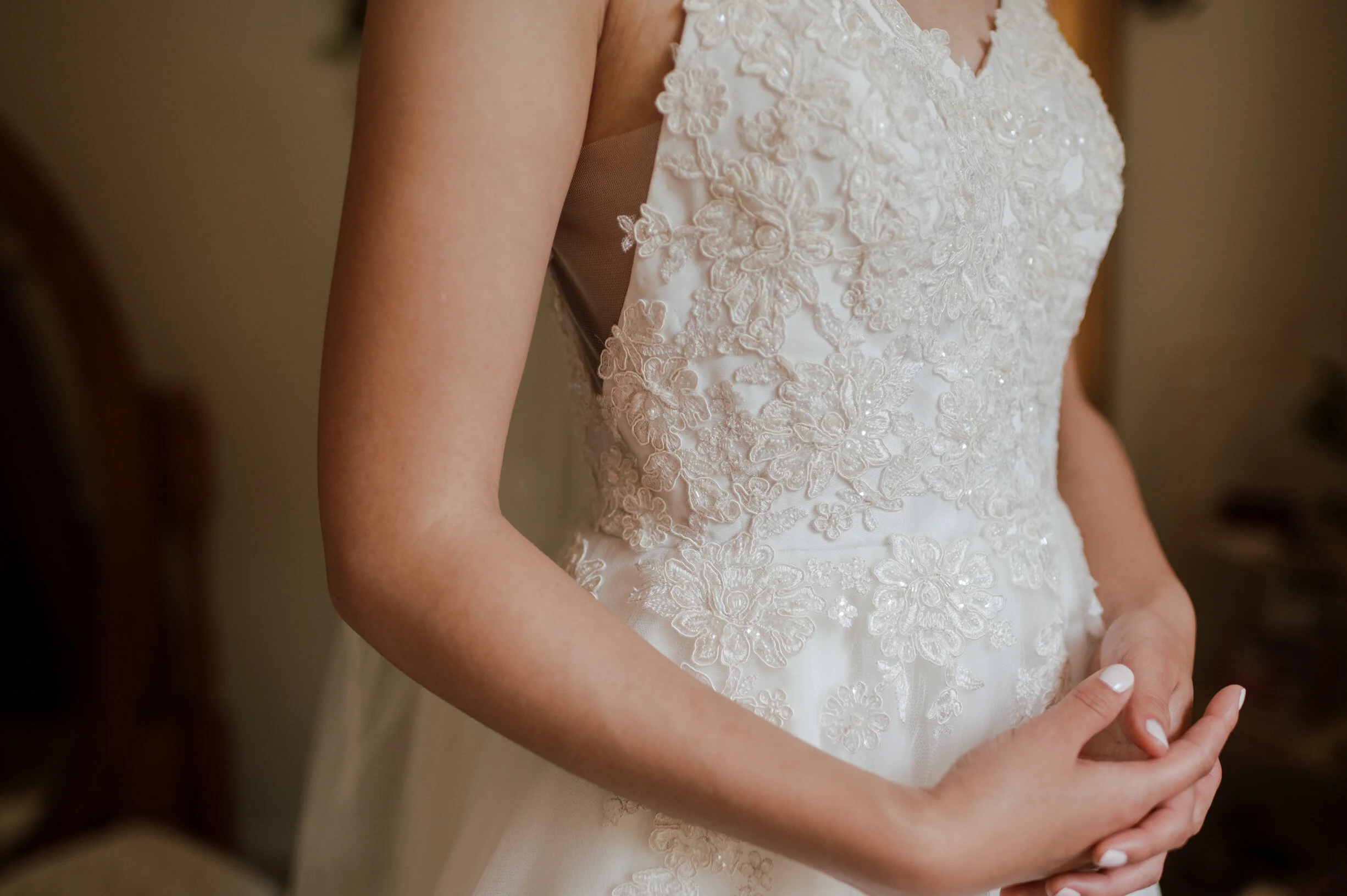  Out of the dozens of bridal lace samples, Emily and David fell in love with an elaborate floral lace that was corded and beaded with silver filigree thread around the edges (Victoria). Fabric was sourced from Bridal Fabrics, a family run business in