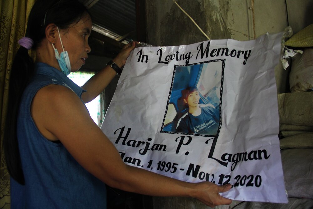  Linda shows the ‘In Loving Memory’ sign used during Harjan’s burial. Linda recalls that her son was on his way home when he was abducted on Nov. 11, 2020. The following day, his headless remains were found. 