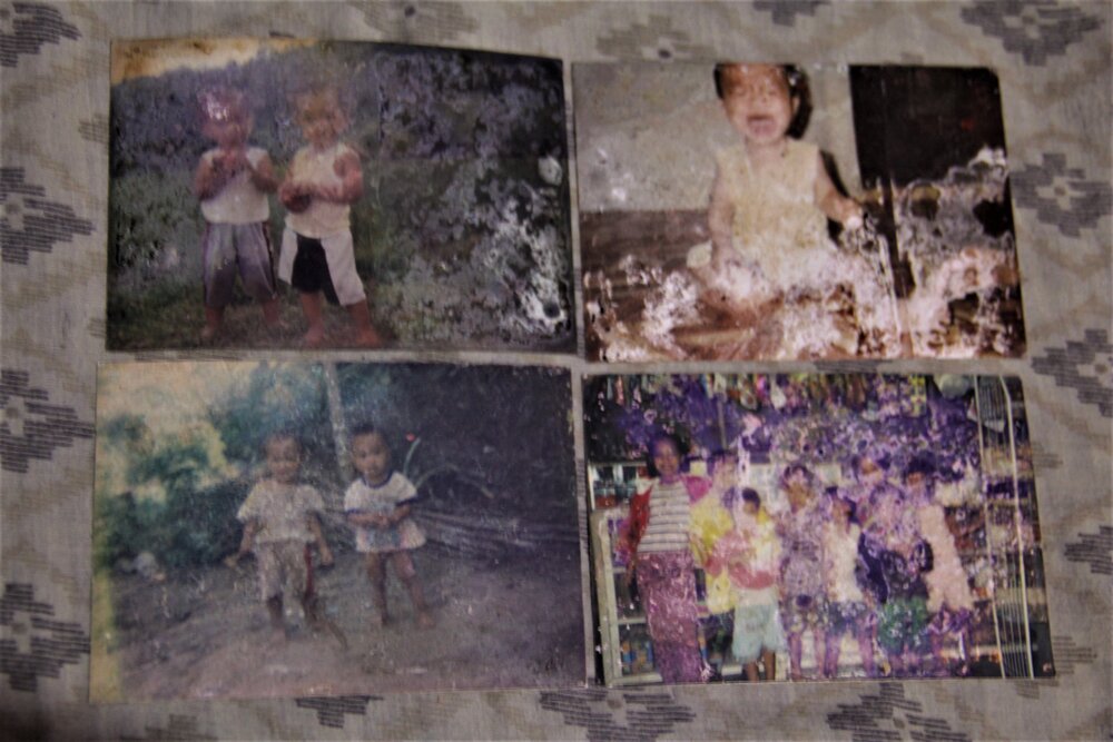  Baby photographs of Harjan Lagman are laid out in his room. Harjan’s parents describe their son as simple and hardworking. He was able to help the family cope with the difficulties brought about by the pandemic. 