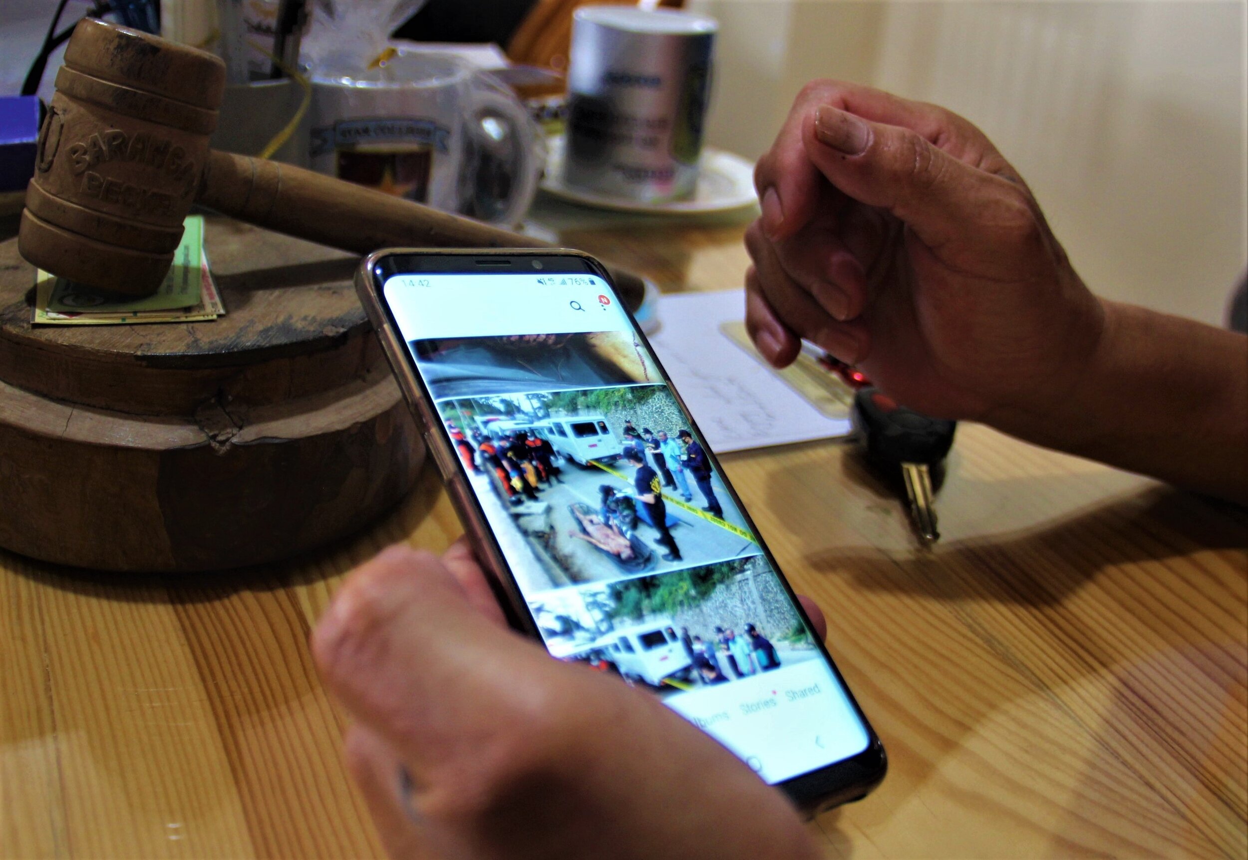  Barangay Chairman Antonio Gregorio shows photos of the retrieval operation for an unclaimed body, whose naked remains were found in a ravine near Lamut Junction at Barangay Beckel in La Trinidad, Benguet on Feb. 27, 2020. On the same day, another bo