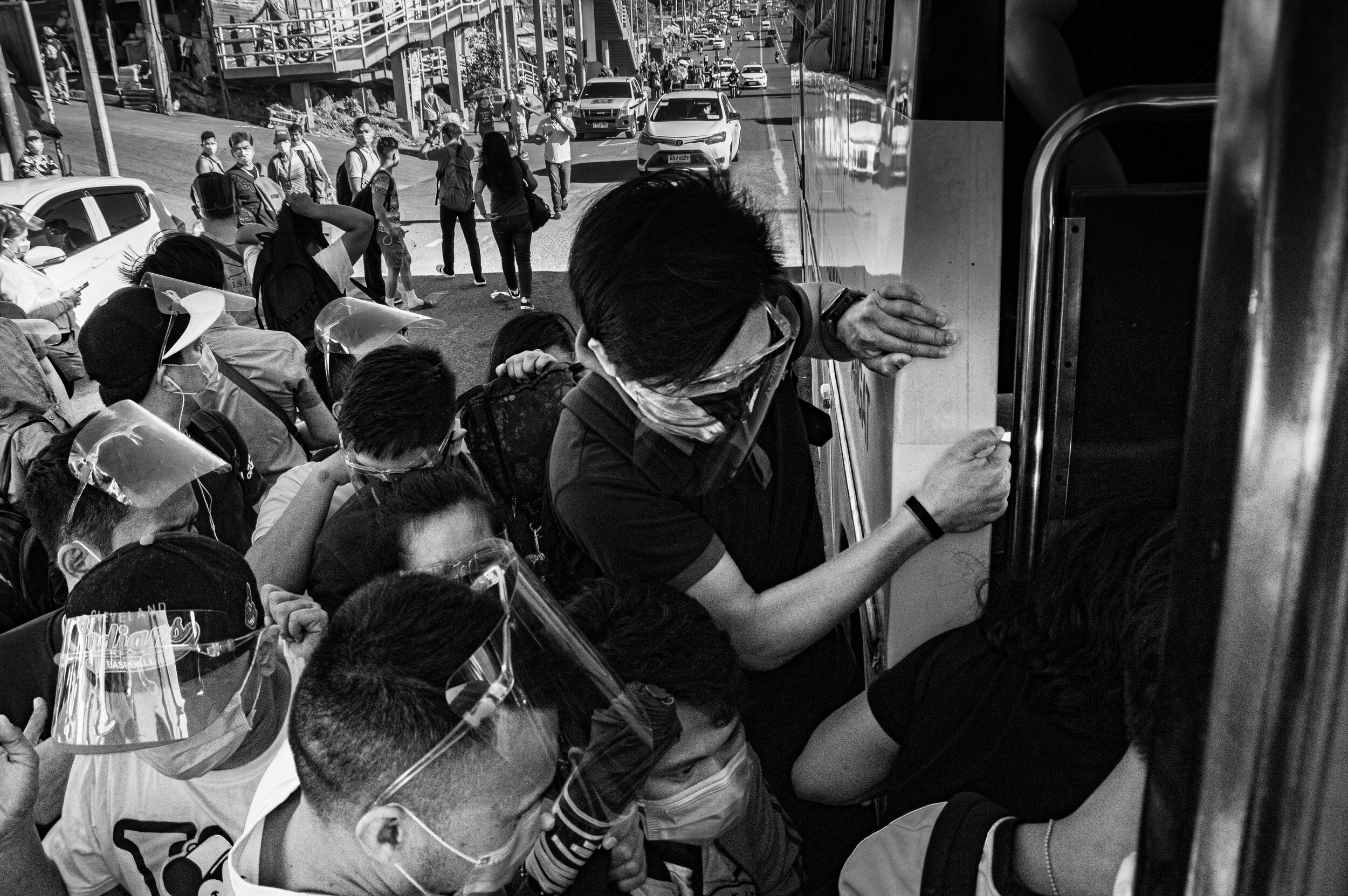 Commuters struggle to get on a bus on Commonwealth Avenue in Quezon City after the government reimposed the stricter enhanced community quarantine in Metro Manila, Bulacan, Cavite, Rizal, and Laguna on March 29, 2021. Covid-19 cases in the country h