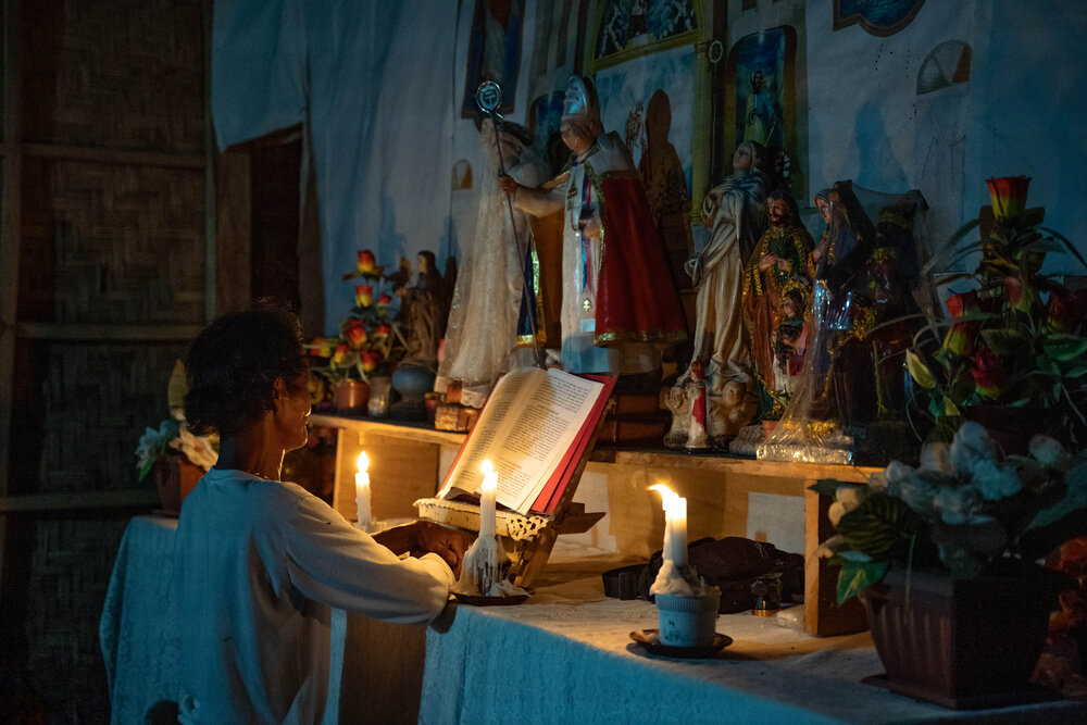  An Aeta devotee of the Crusaders of the Divine Church of Christ in Sitio Kawayan kneels before the chapel’s altar to pray. Other religious orders and benevolent groups are recognized by Aeta communities in Capas, Tarlac. Even within these denominati