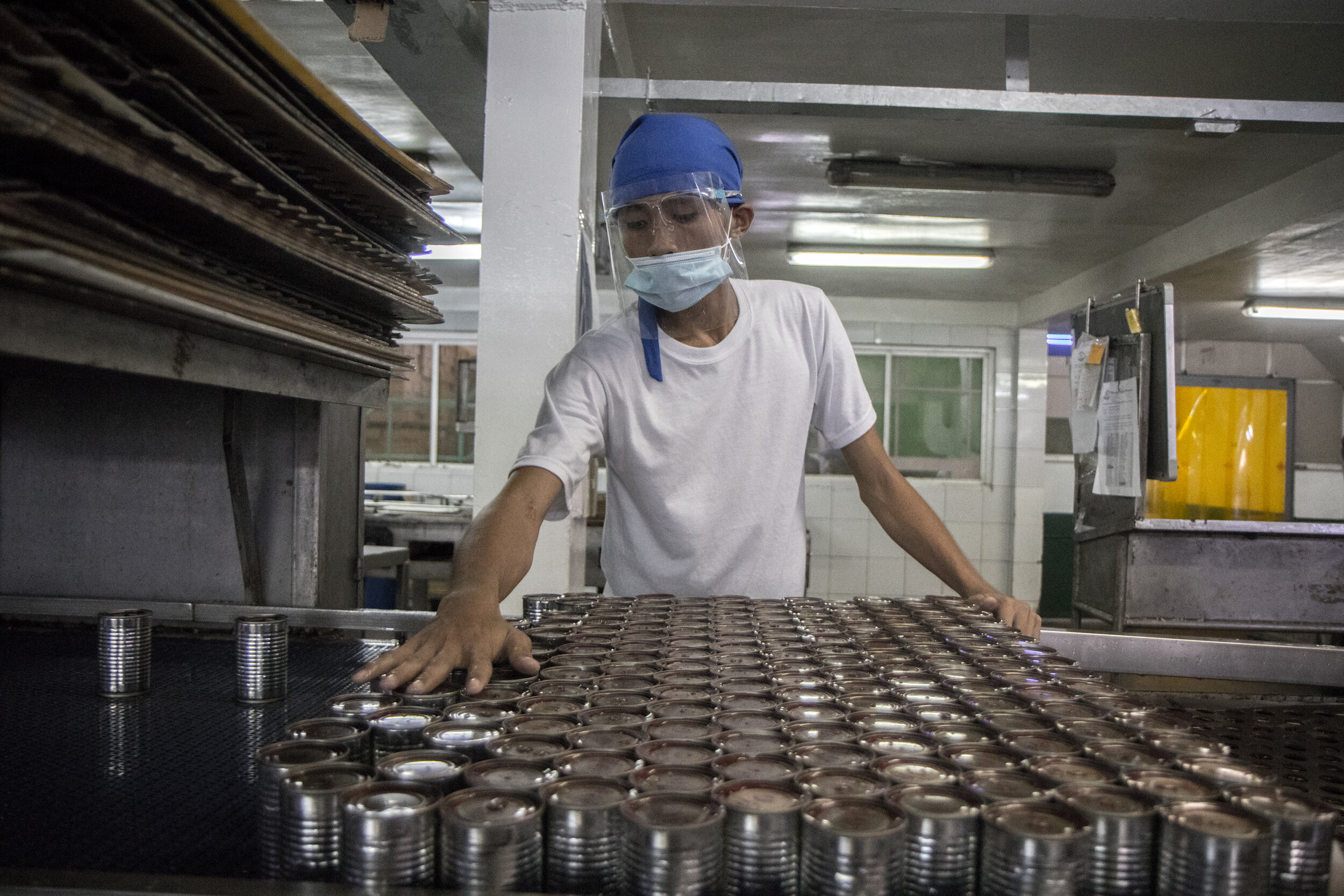  A worker sorts the cans and does a final check for leaks. After a can is sealed, the last step is to put labels on the can. 