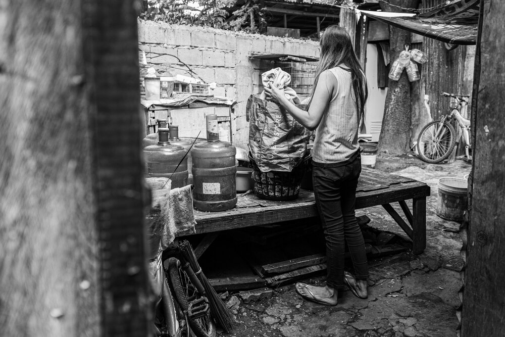  Mace arranges her laundry at the back of her house in Cainta, Rizal on March 23, 2021. She lives in a small shack divided into two cramped spaces for her bedroom and a  sari-sari  or neighborhood store. She pays P500 for her monthly rent. Since the 