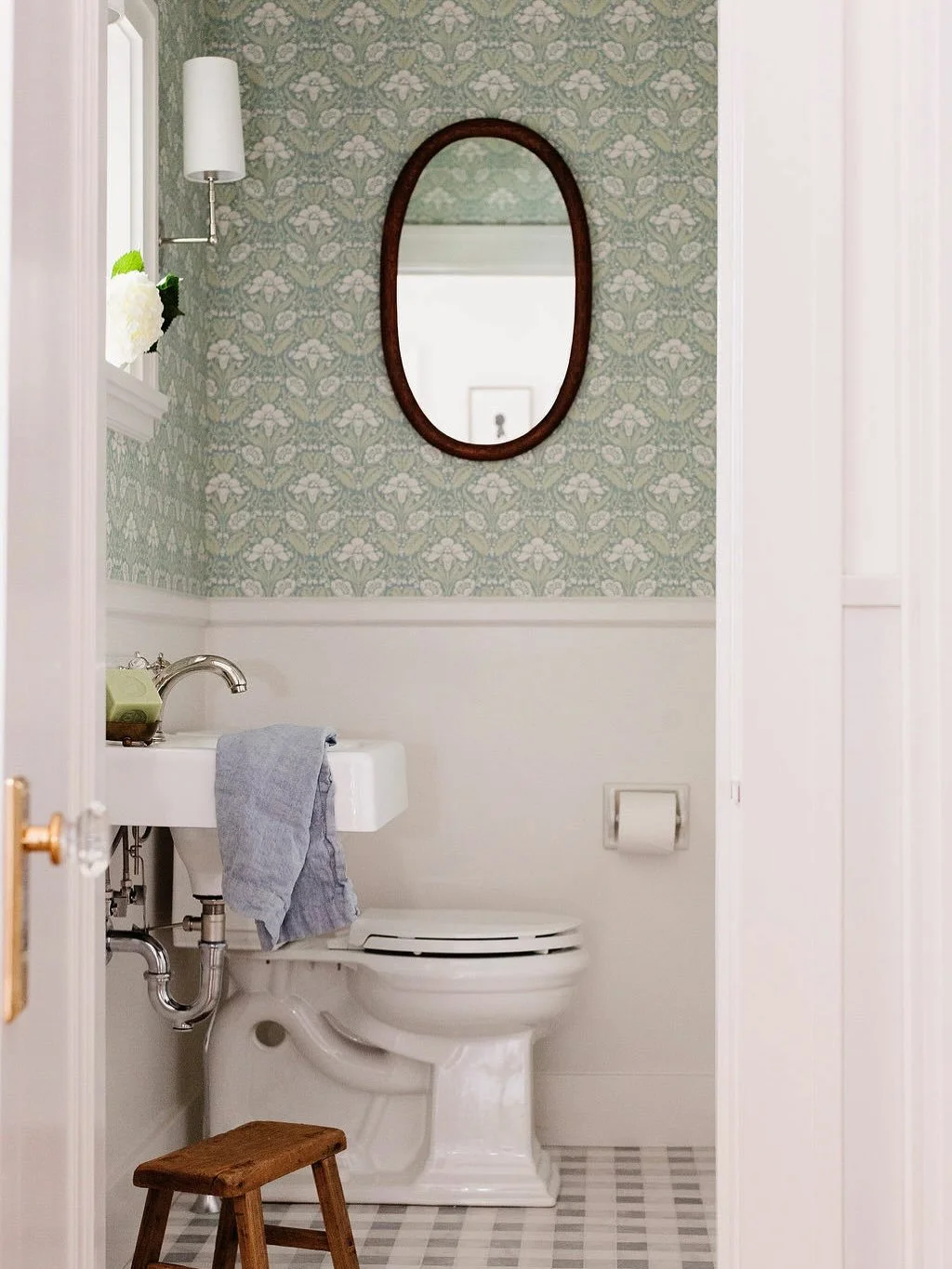 The nearby powder room was reimagined with whimsy and elegance: a garden-inspired wallpaper, charming marble tile floor, and updated fittings create a space that feels special and unexpected.

#interiorrenovation
#powderroomdesign
#powderroomrenovati
