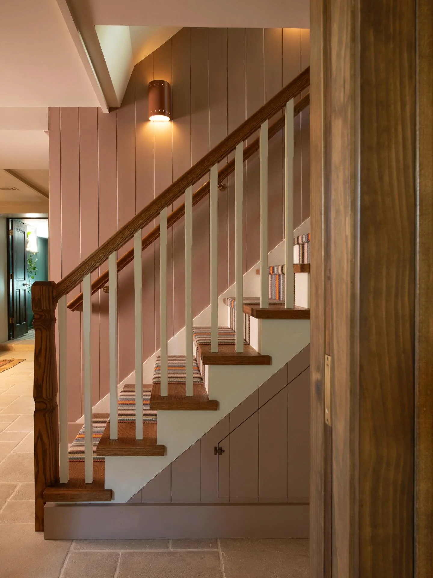 The original basement staircase&mdash;narrow and unsafe&mdash;was removed and rebuilt as a wider, more gracious stair featuring oak treads with eased-edge nosing. Structural posts were strategically integrated into new walls for a seamless architectu