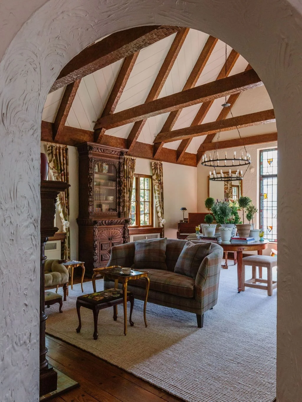 This gorgeous Tudor living space already had incredible character &mdash; vaulted ceilings, original wood beams, and stained glass windows.

Our goal was to honor those architectural details while creating a brighter, more functional space for everyd