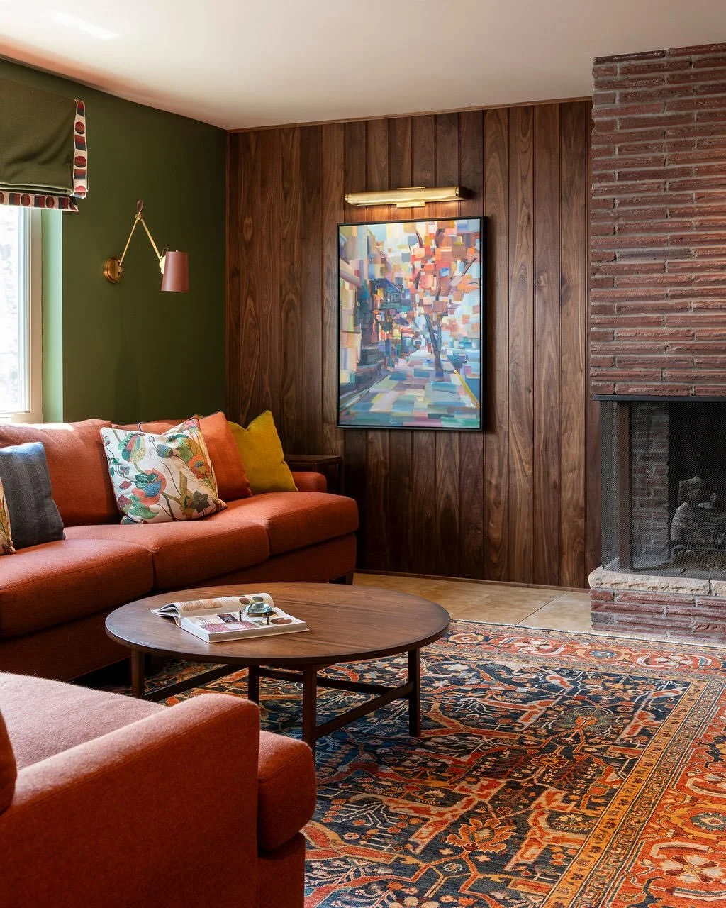 This cozy, library-inspired lower level retreat was designed for everyday living and entertaining. 

Inspired by the home&rsquo;s mid-century architecture, rich walnut paneling, built-in bookcases, heated stone floors, and a curated mix of colorful f