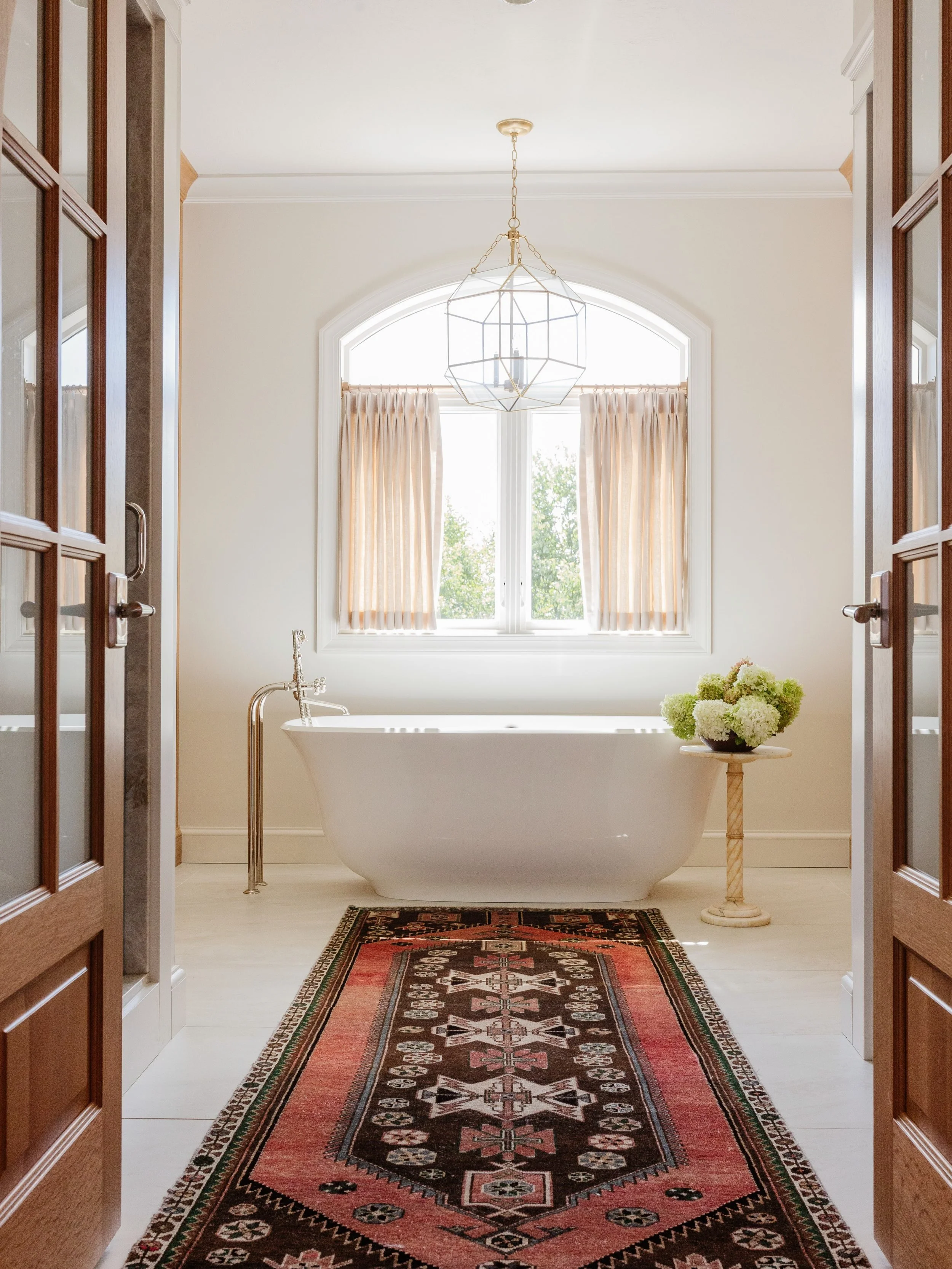 This primary suite renovation completely reimagines the layout of both the bedroom and bathroom, with an emphasis on efficient use of space, symmetry, and thoughtful functionality. By strategically removing and adding windows, we created a beautifull