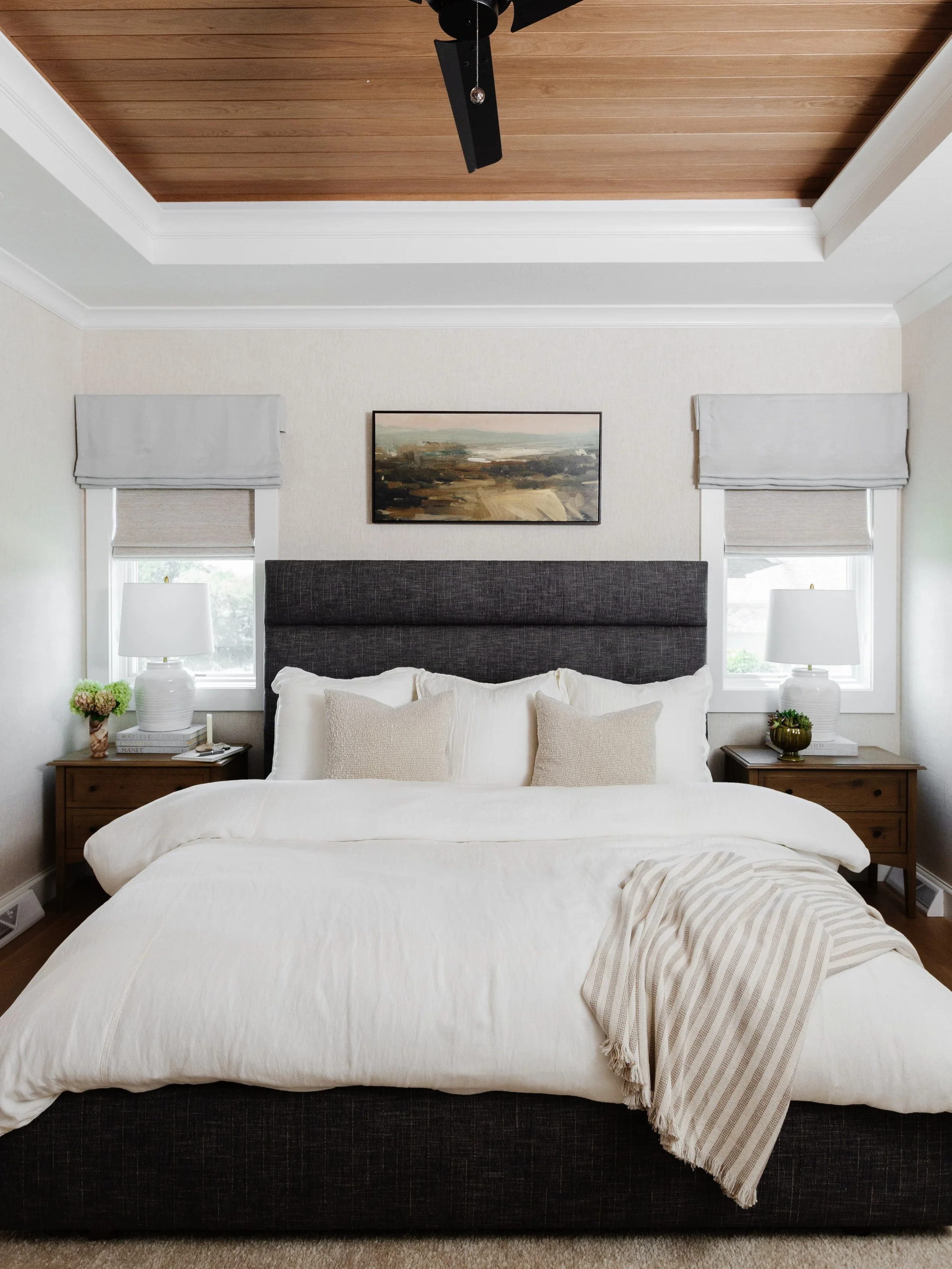 In the bedroom, storage was a key priority, inspiring a tailored his-and-hers closet solution: a highly functional built-in wardrobe in the bedroom for him and a dedicated walk-in closet for her.

A moody custom-upholstered bed, generously sized nigh