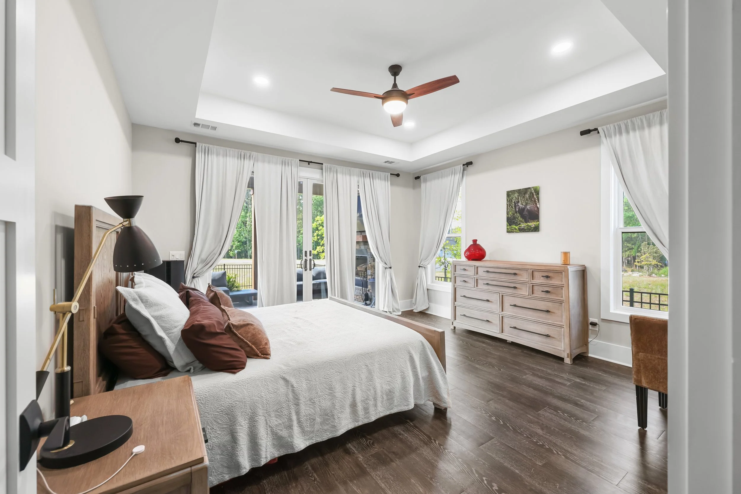Owner's suite with glass sliders to the back patio, tiled shower, soaker tub, and dual vanities