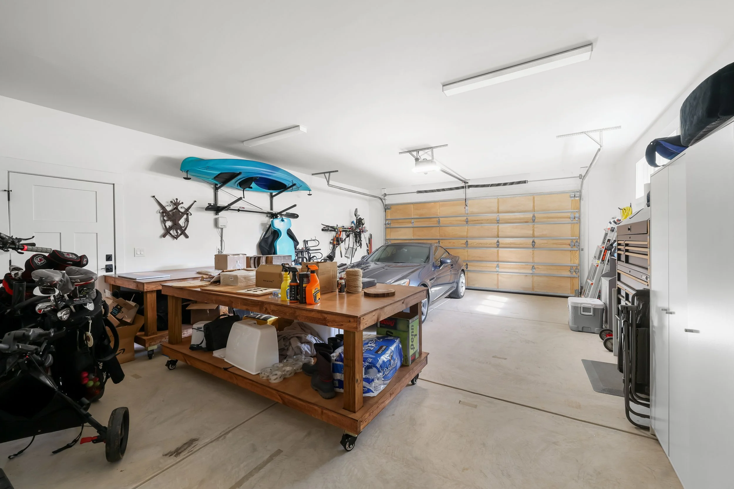 Extra-deep 4-car garage with custom wood garage doors and exterior side door