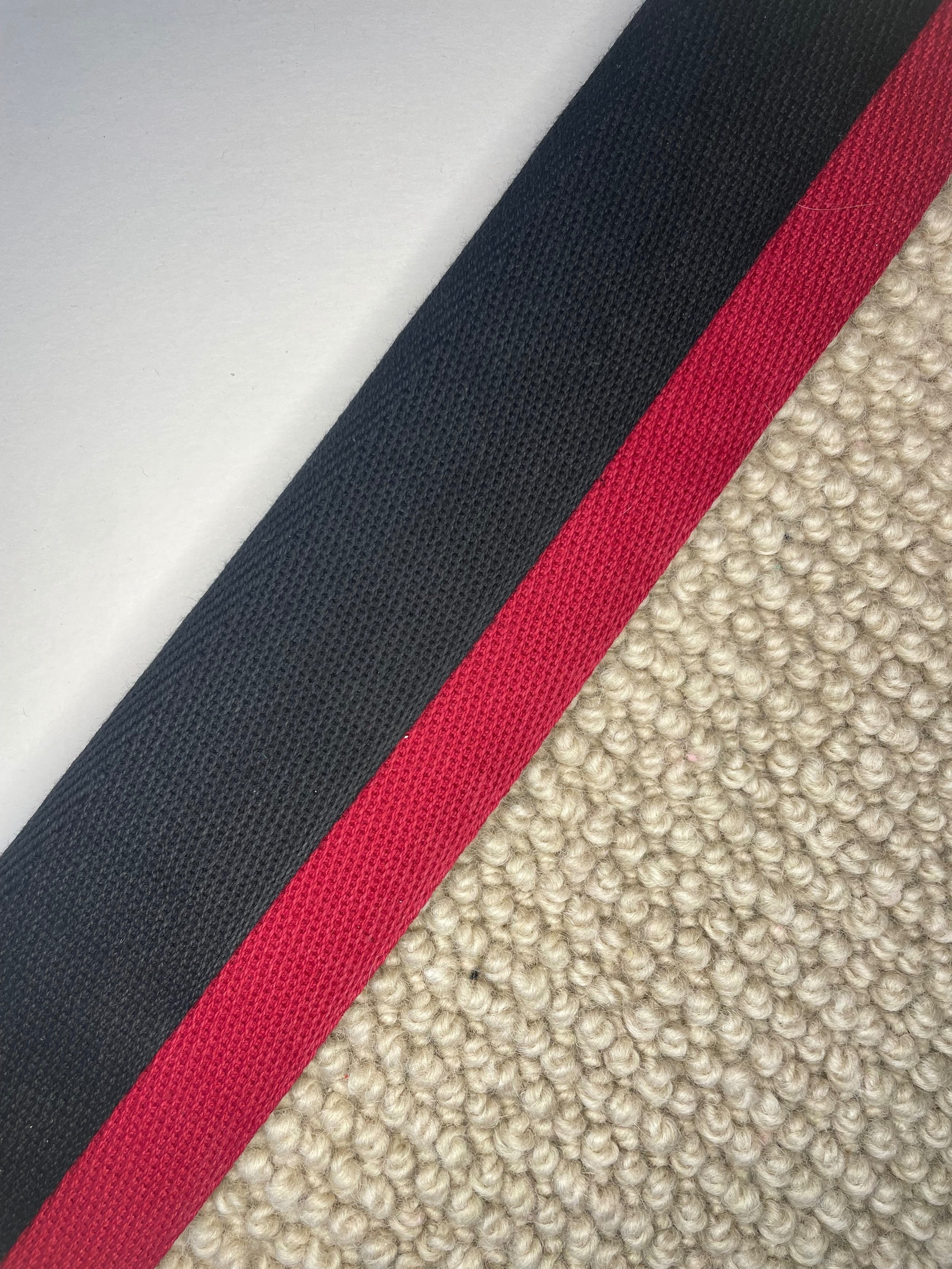 Black and red double herringbone carpet edging border for stair runners and rugs. Stair runner with piping tape edge.