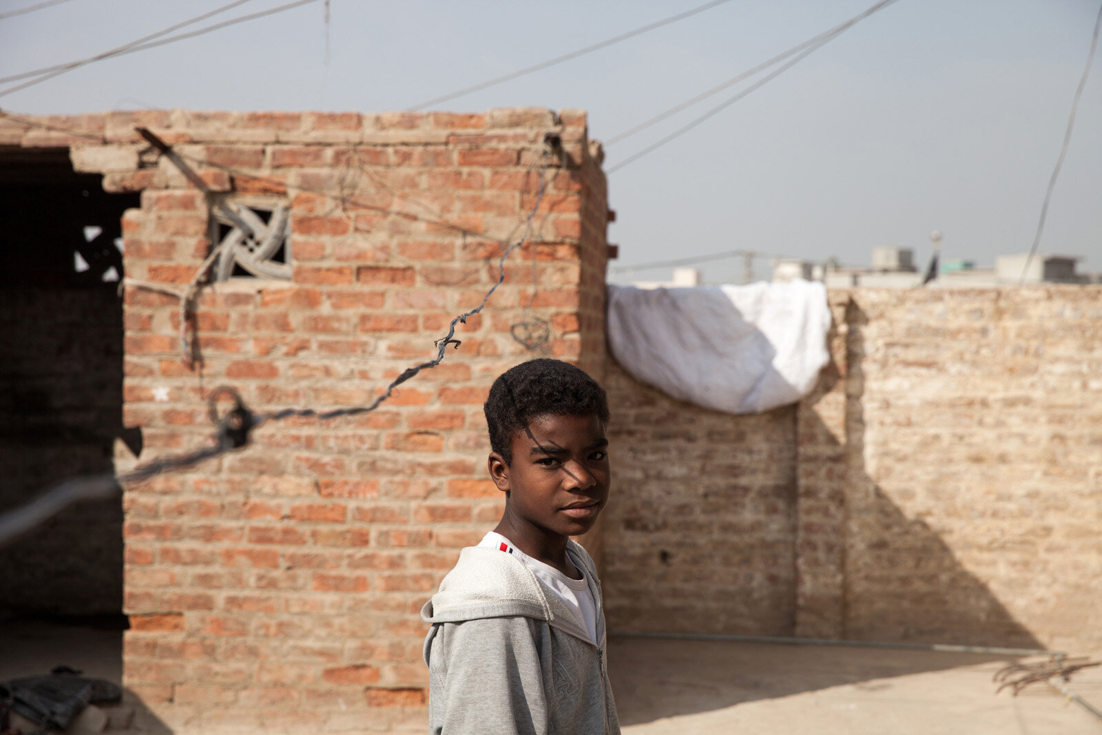 A Sheedi boy stands on the roof of his house in a suburb of Hyderabad.