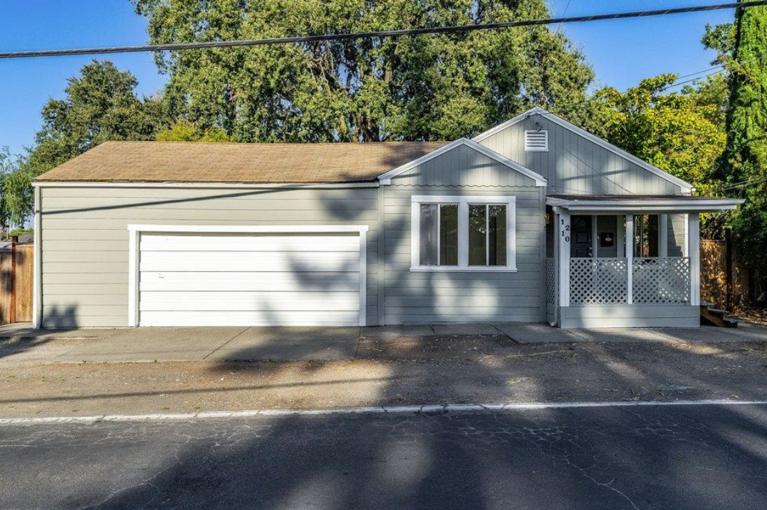 Front exterior of the 2-bedroom home for sale at 1210 Ridley Avenue in Santa Rosa, California featuring a two-car garage, covered front porch, and inviting curb appeal.