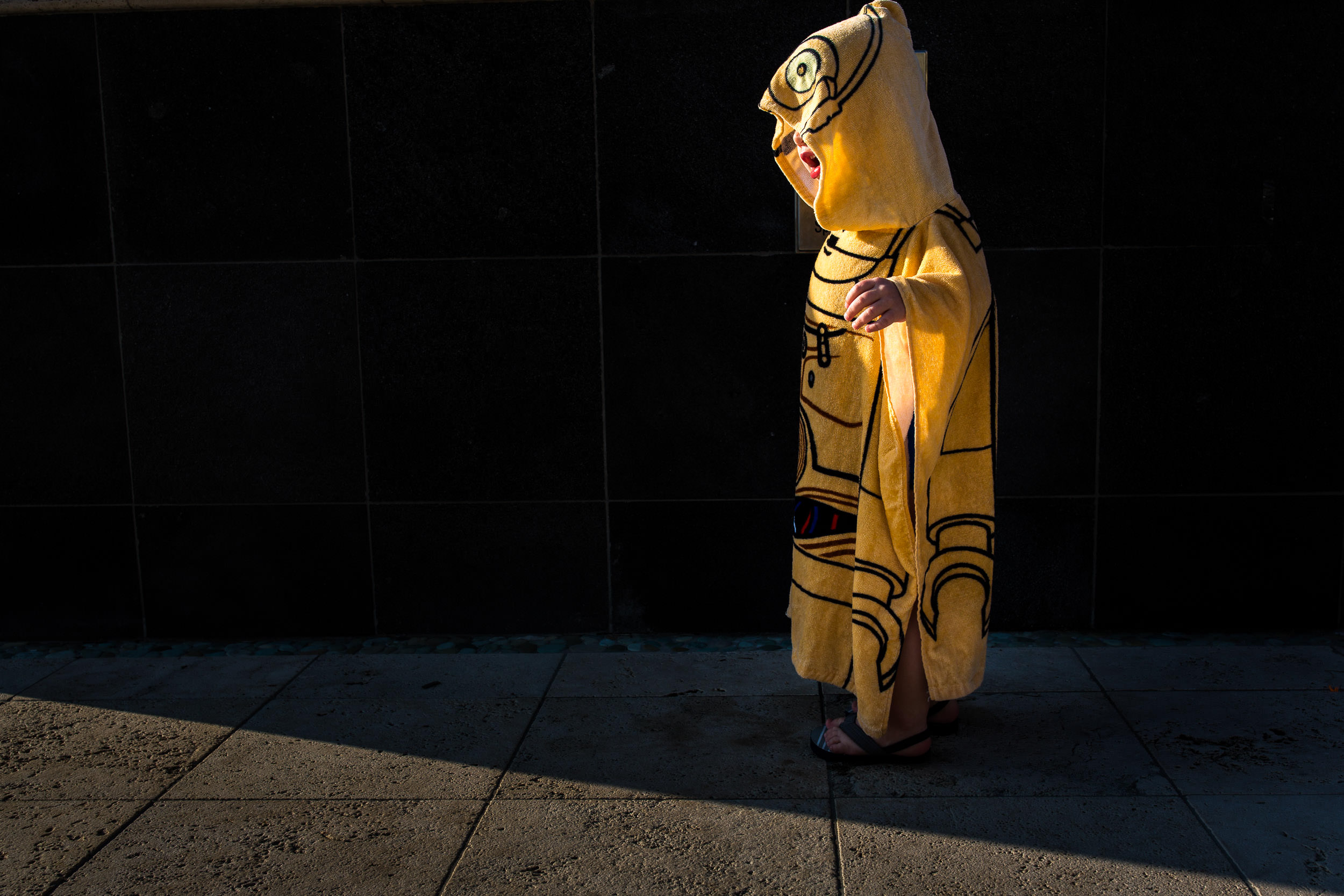 Boy dressed in a C-3PO hooded towel