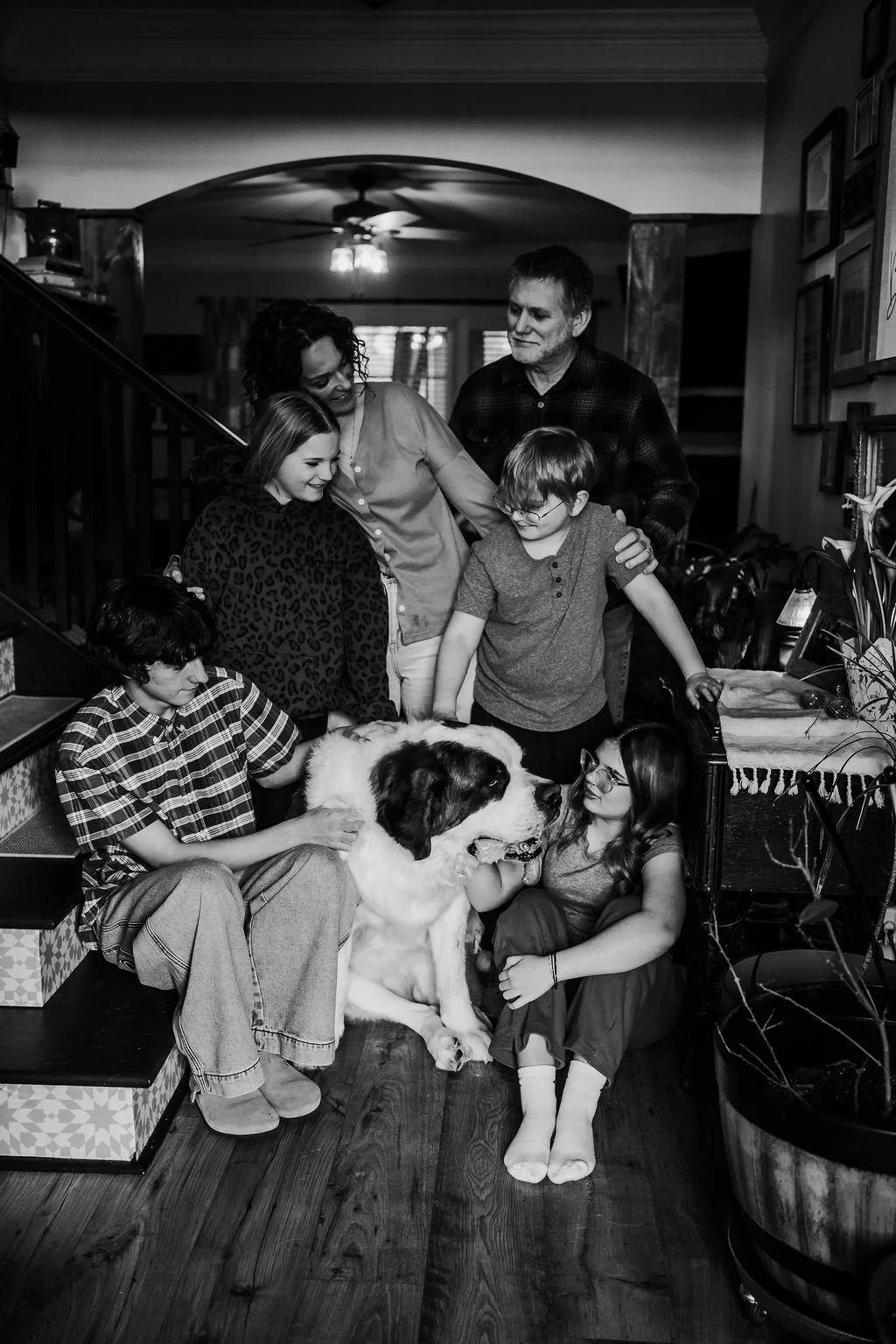 Family enjoying an in-home photography session with their dog in North Alabama