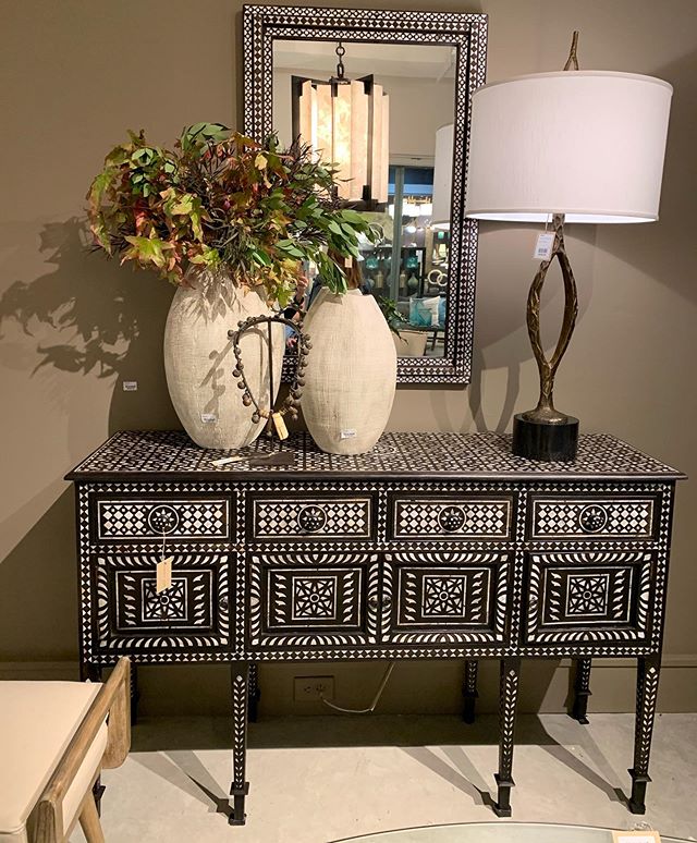 Inlayed bone chest and mirror anchor this organic vignette @globalviews.