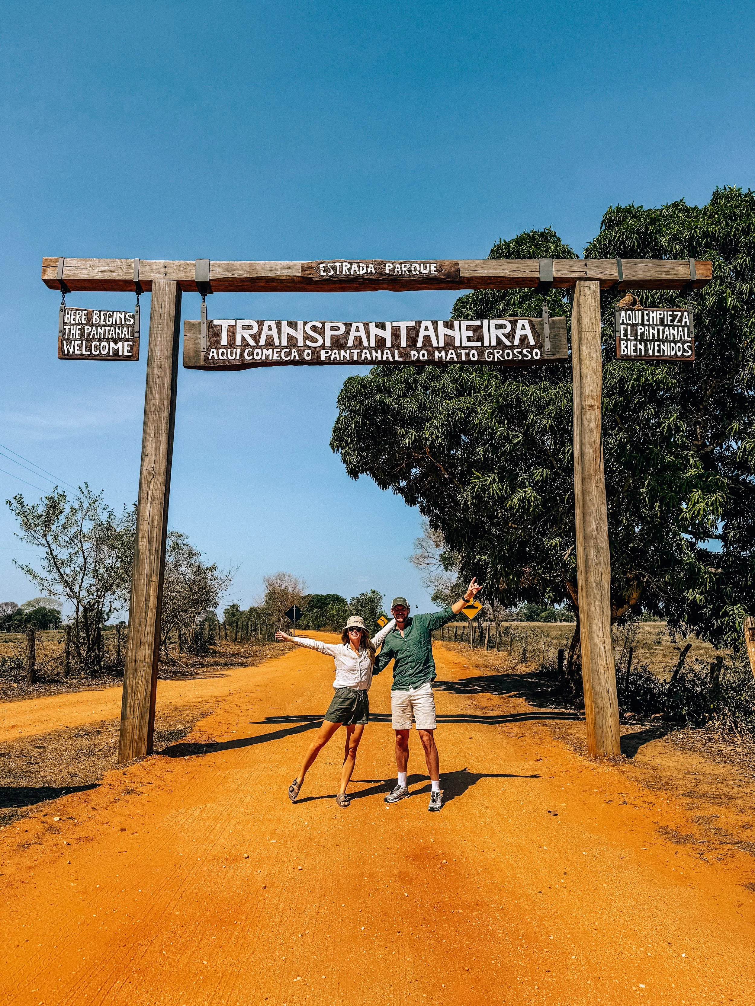 Kellie Paxian and her husband under the Transpantaneira welcome sign at the start of the Pantanal, Mato Grosso, Brazil