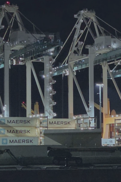 Shipping port with cargo cranes and containers, representing maritime infrastructure facing increasing cybersecurity threats.