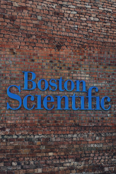 Boston Scientific logo displayed on a brick wall.
