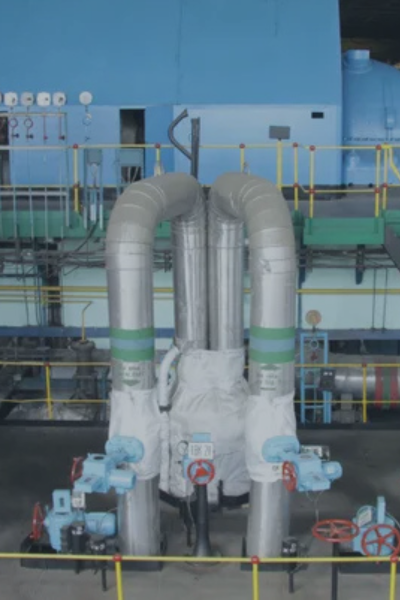 Industrial facility piping and infrastructure, representing cyber-physical system threats targeting critical infrastructure providers.