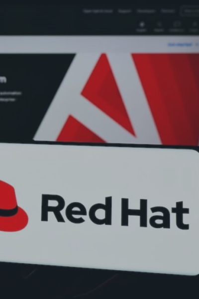 Red Hat logo featured in cybersecurity news about a supply chain attack on NPM packages.