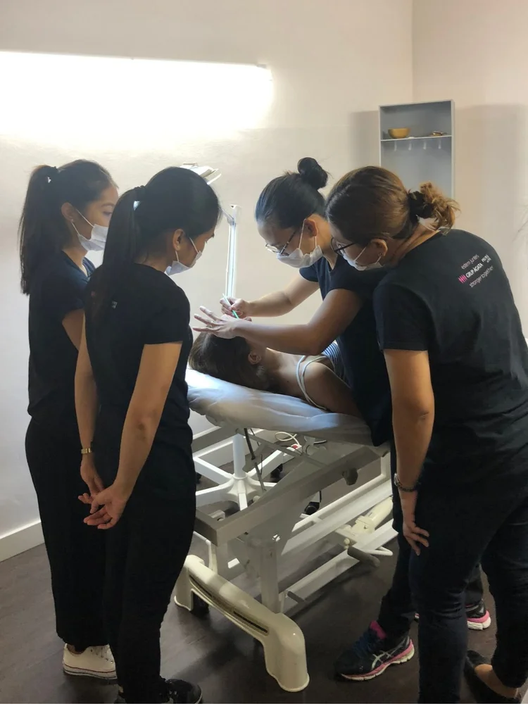 Training students observing live permanent makeup procedure