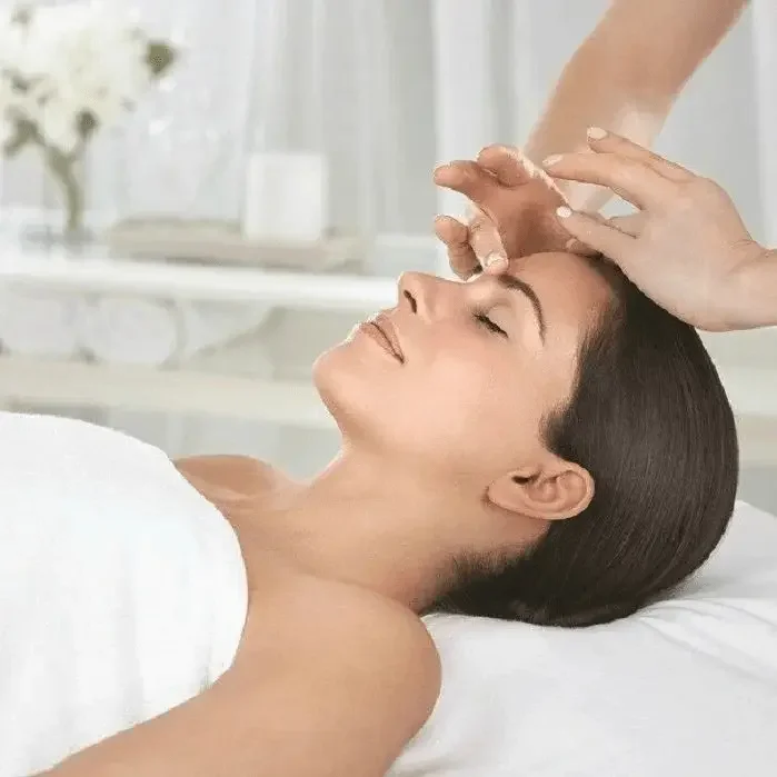 Woman lying on massage table receiving a facial