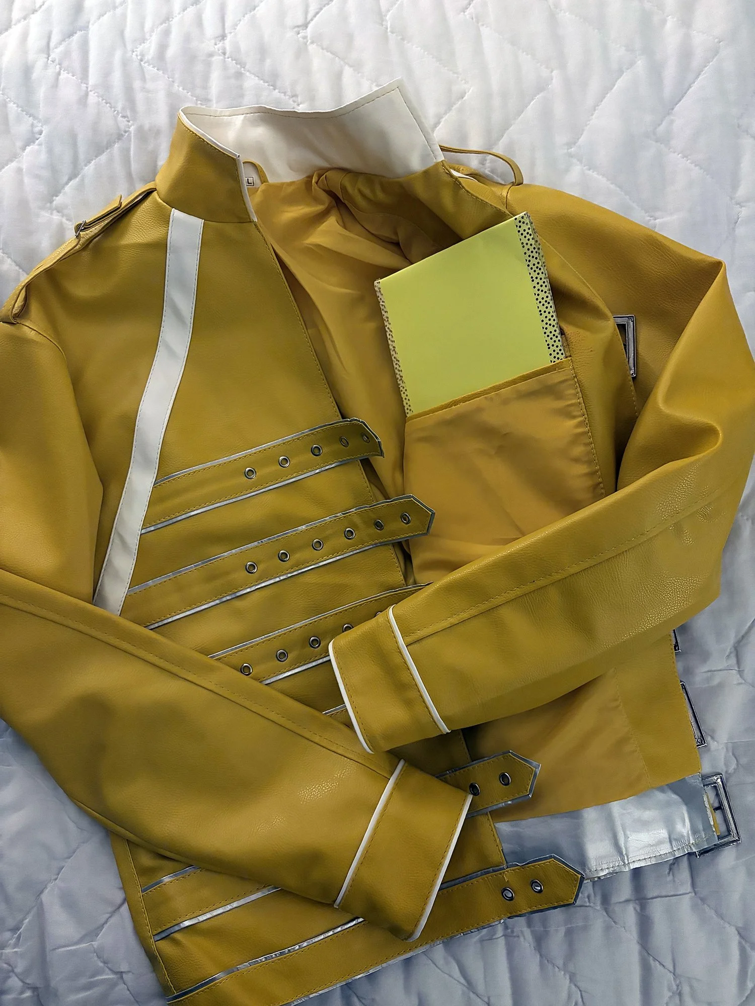 Freddie Mercury yellow buckled jacket with folded poster board in the inside pocket