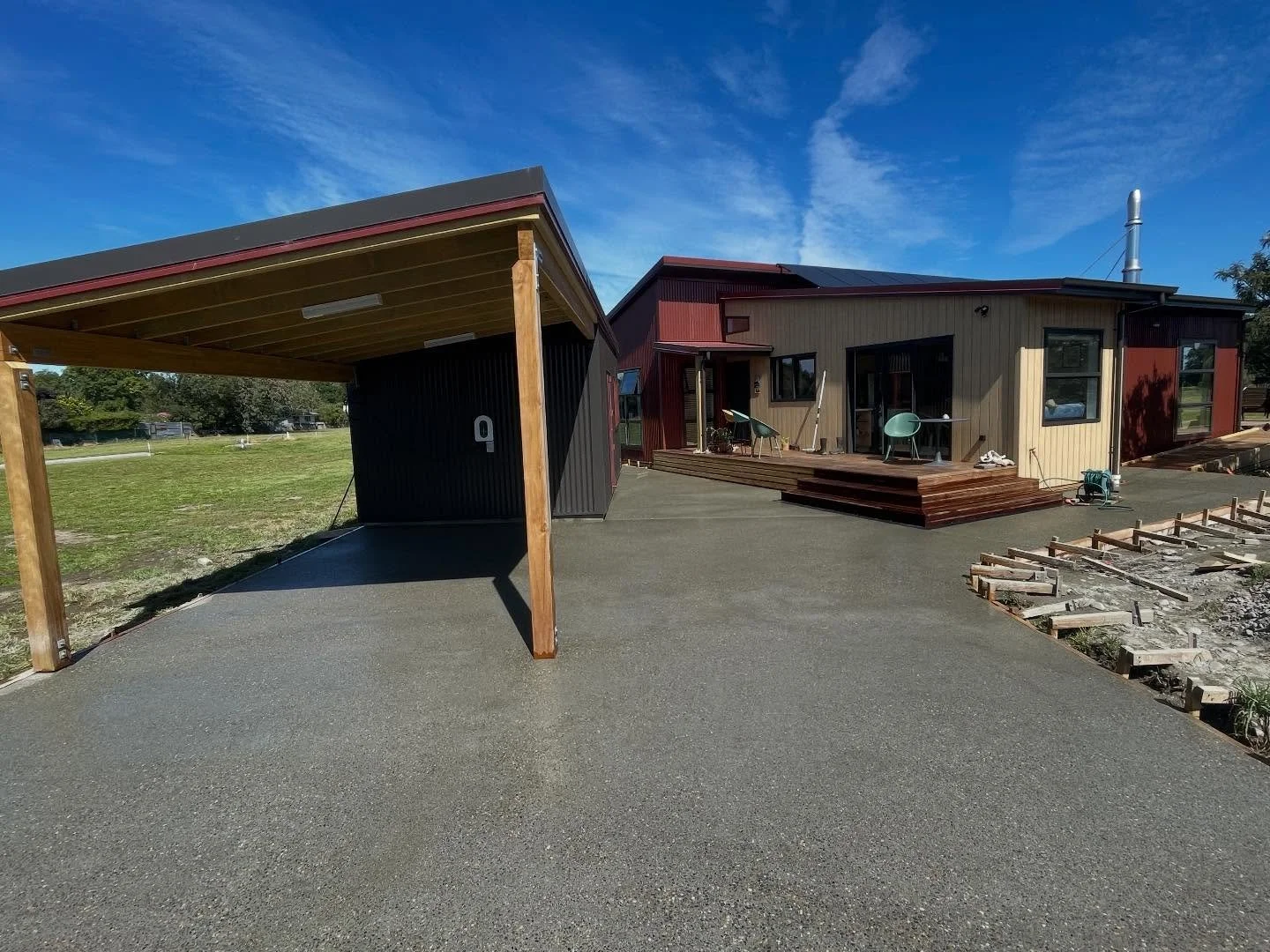 Exposed aggregate driveway and pathways being poured today.

Channel drains have been carefully planned and installed to capture all surface water and direct it away from the house and hard surfaces. Proper drainage planning is essential for longevit