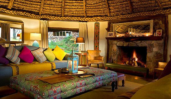 Cosy sitting room with fireplace at Lewa House.jpg