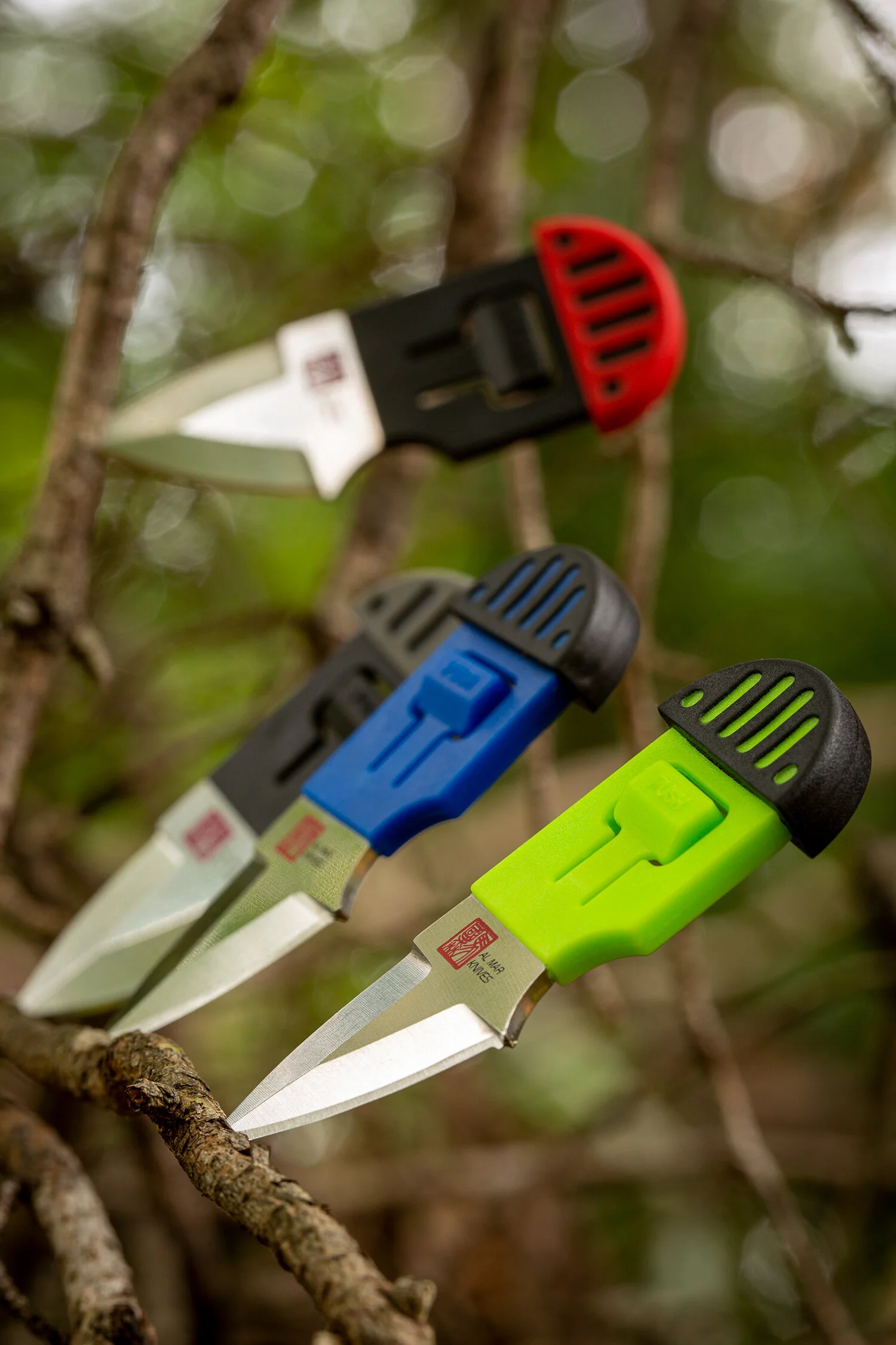 All 4 Al Mar Knives Stigers resting on a branch.