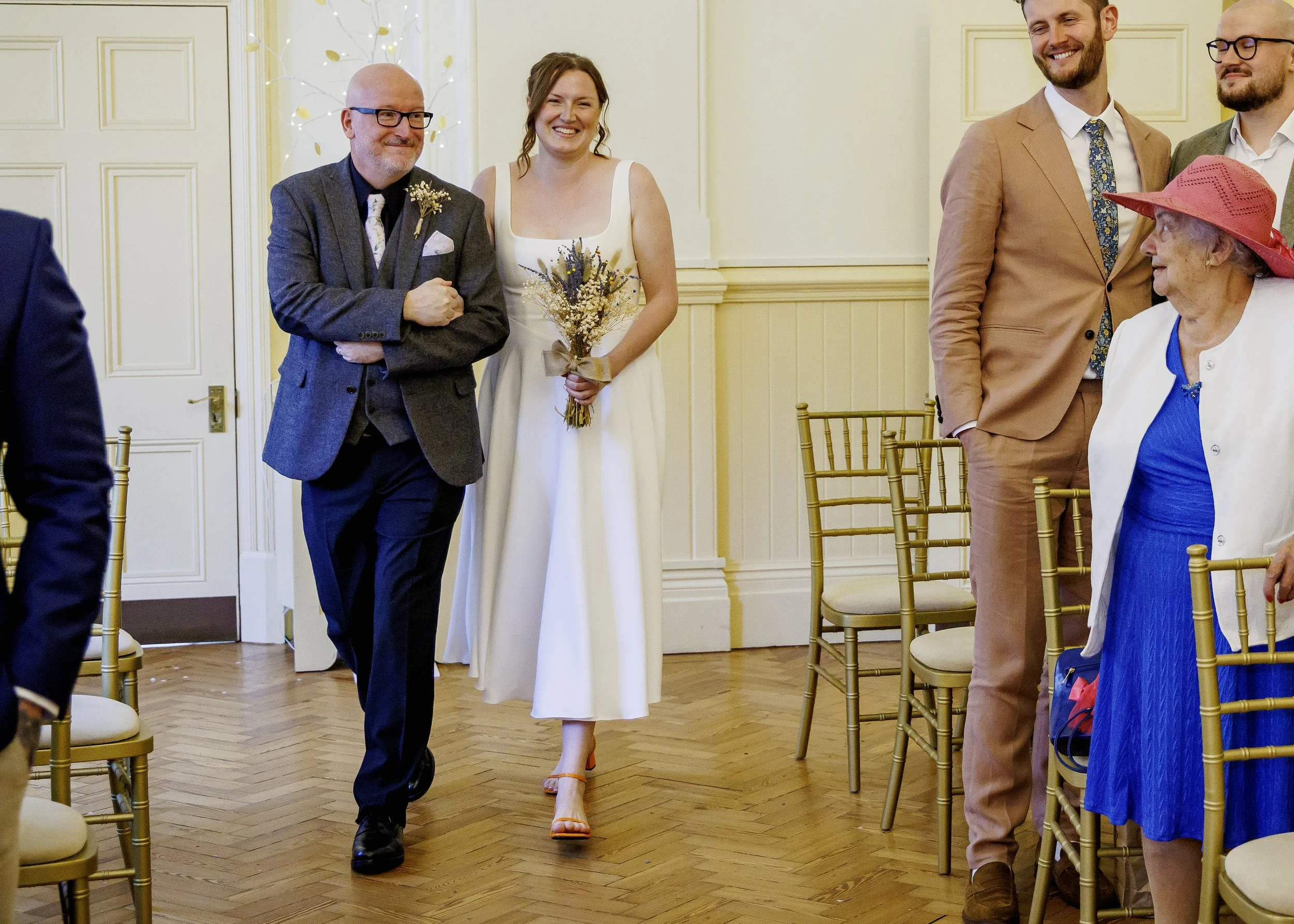 Bride walks down the aisle with her father at an emotional wedding ceremony in the Regency Room at Brighton Town Hall - East Sussex Wedding Photography