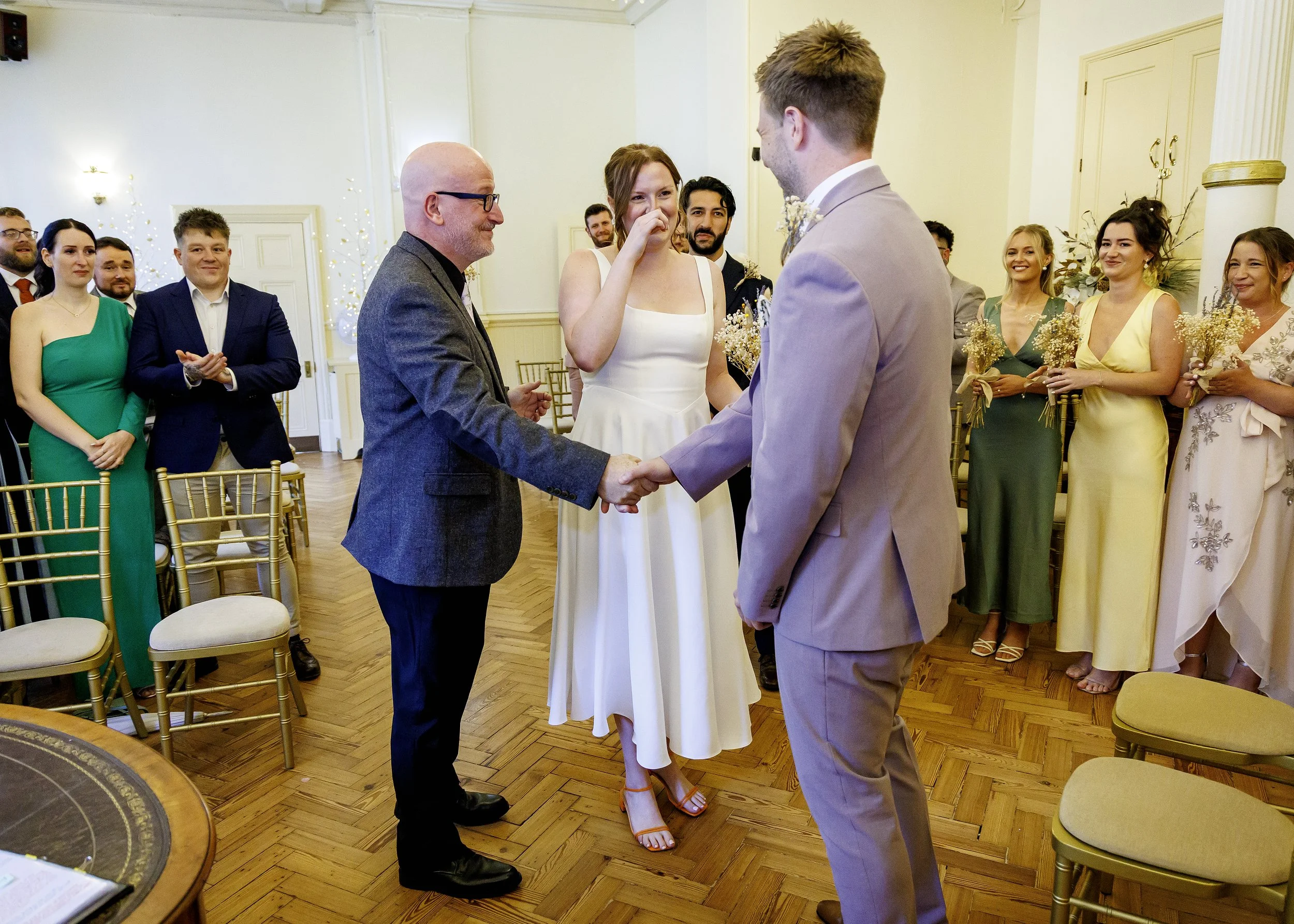 Father of the bride greets groom at a wedding ceremony in the Regency Room at Brighton Town Hall - East Sussex Wedding Photography