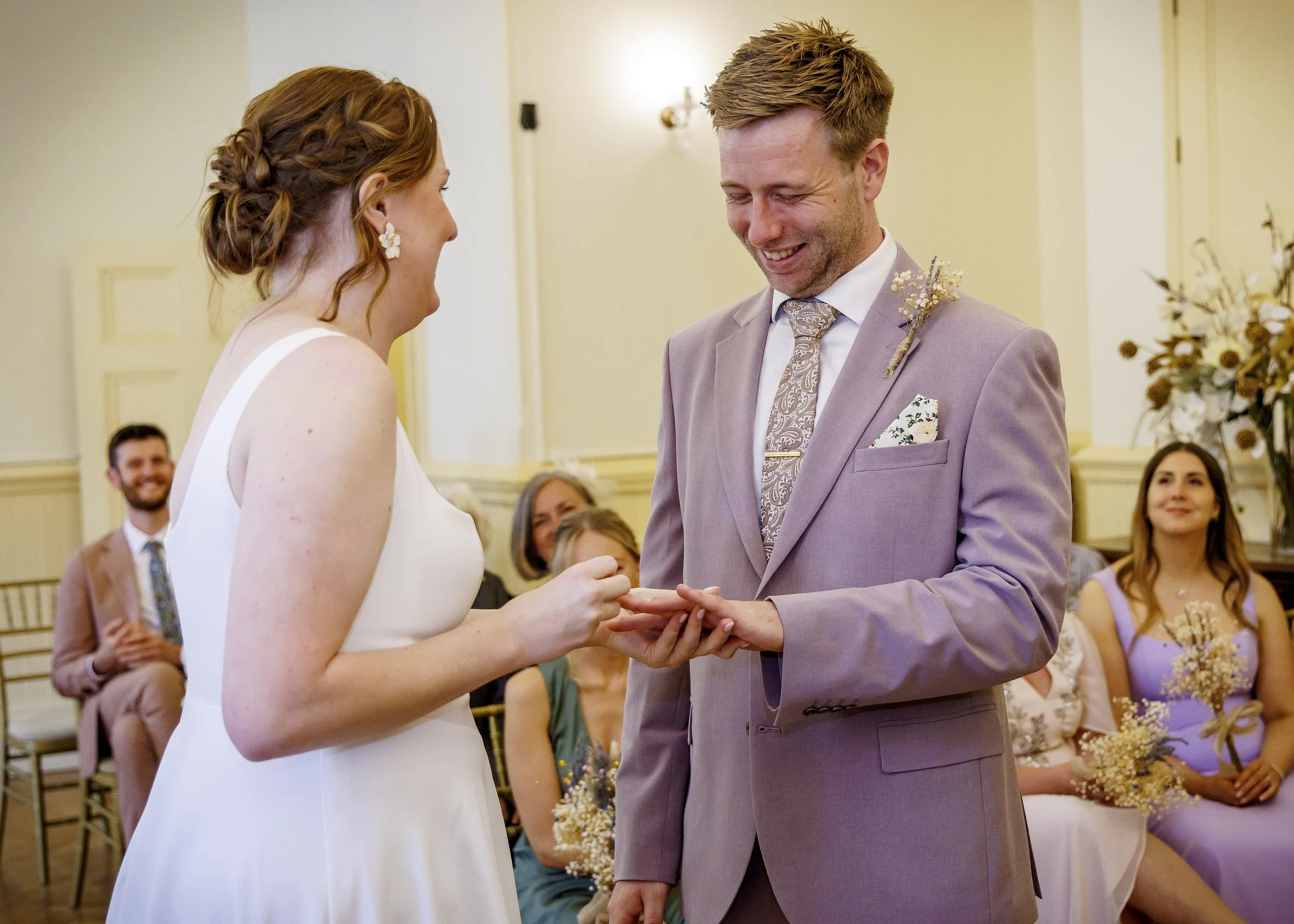 Natural photography of laughter and tears during ring exchange, during a Brighton Regency Suite wedding - Brighton Town Hall, East Sussex Wedding Photographer