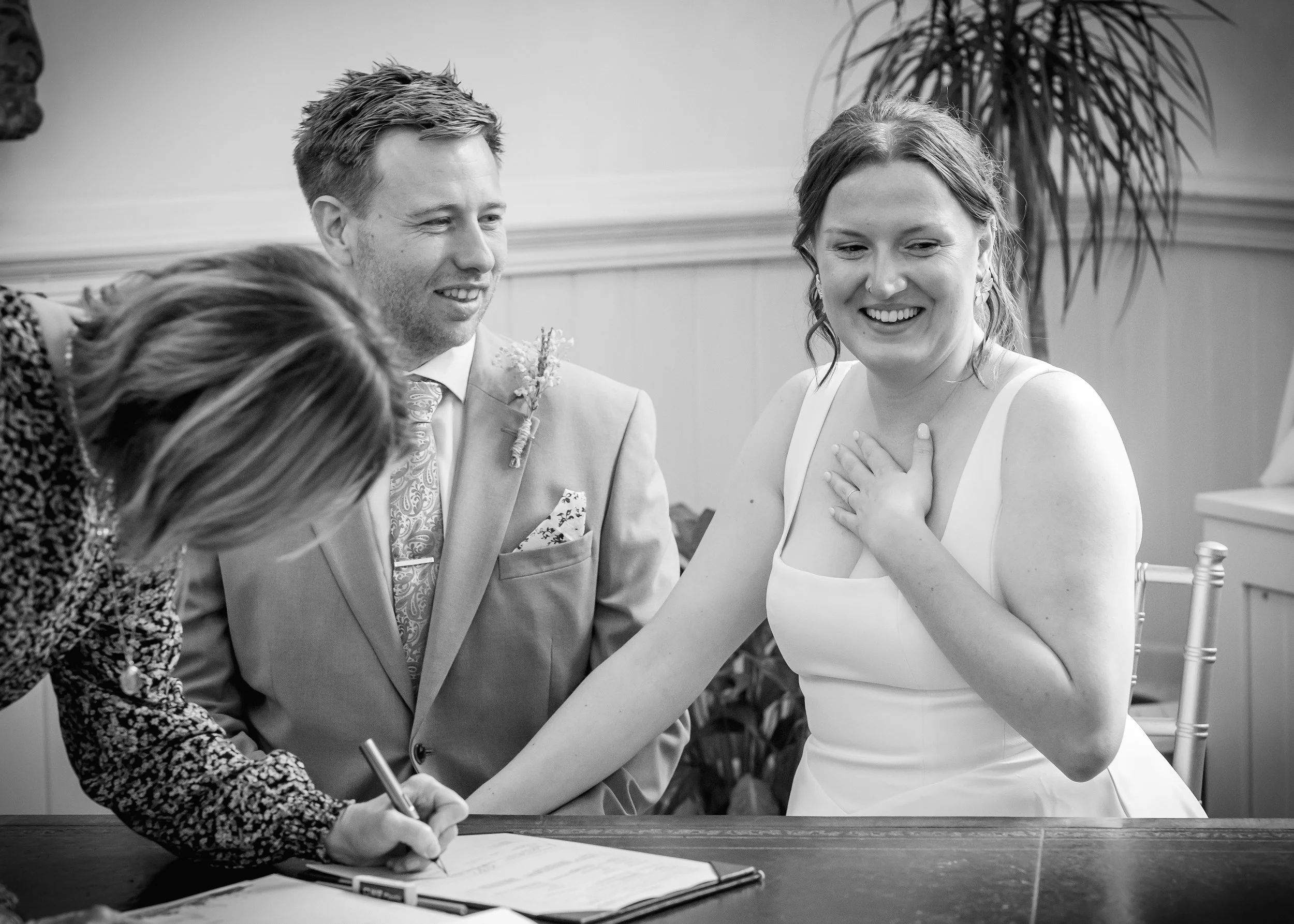 Relief when signing the register in the Regency Room at Brighton Town Hall - East Sussex Wedding Photography