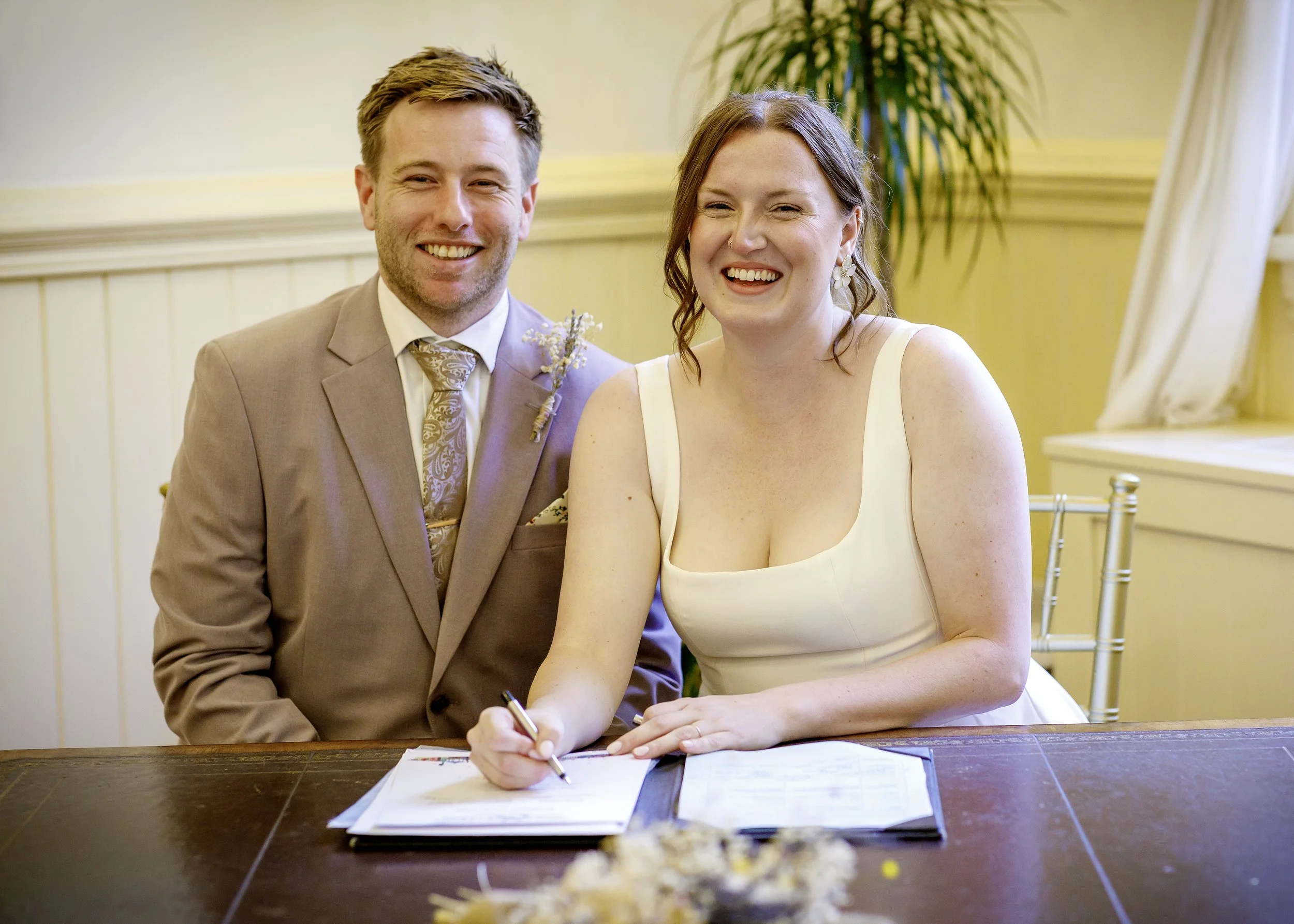 Posed signing the register photo in the Regency Room at Brighton Town Hall - East Sussex Wedding Photography