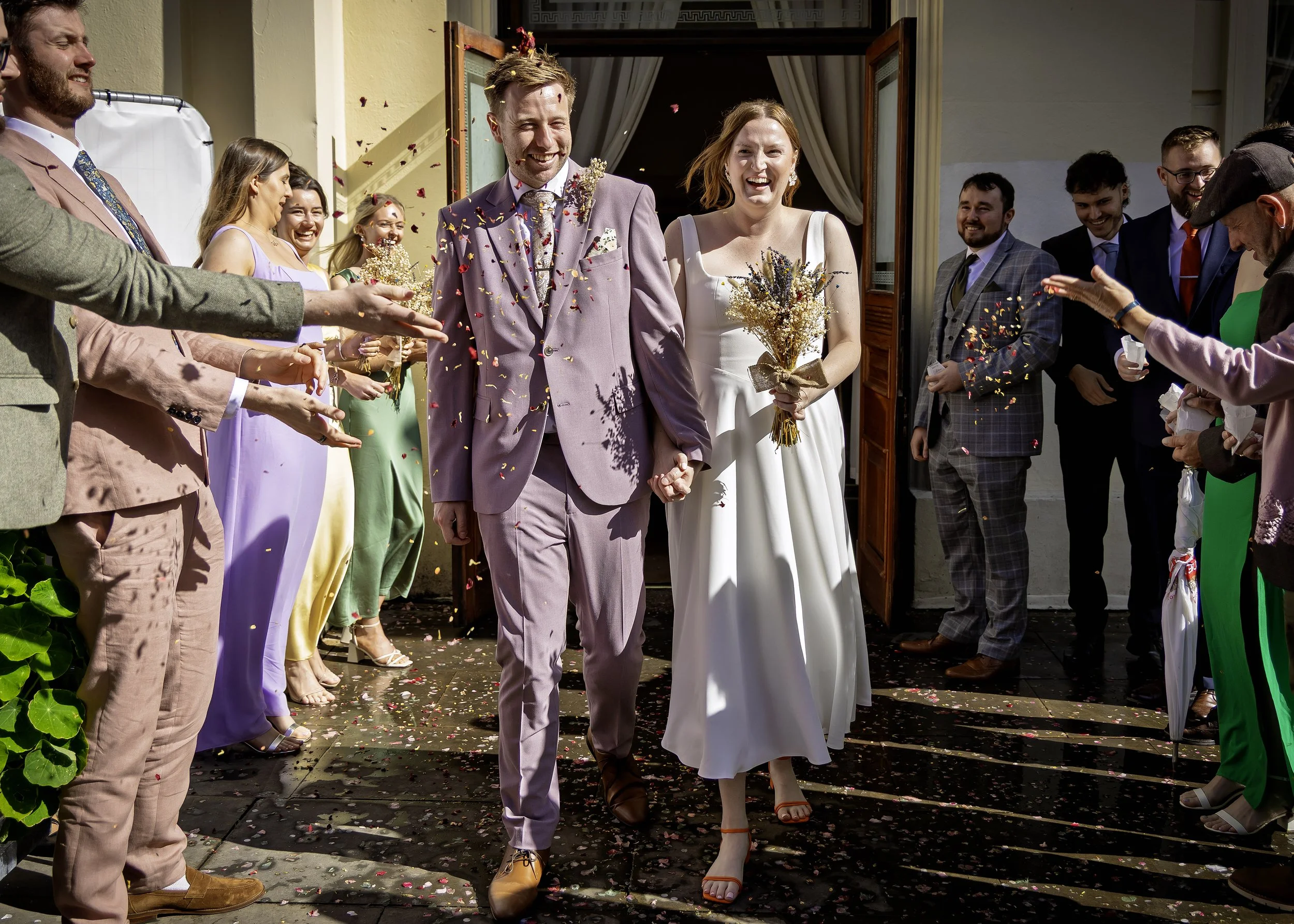 Sun-drenched wedding confetti on the steps of Brighton Town Hall
