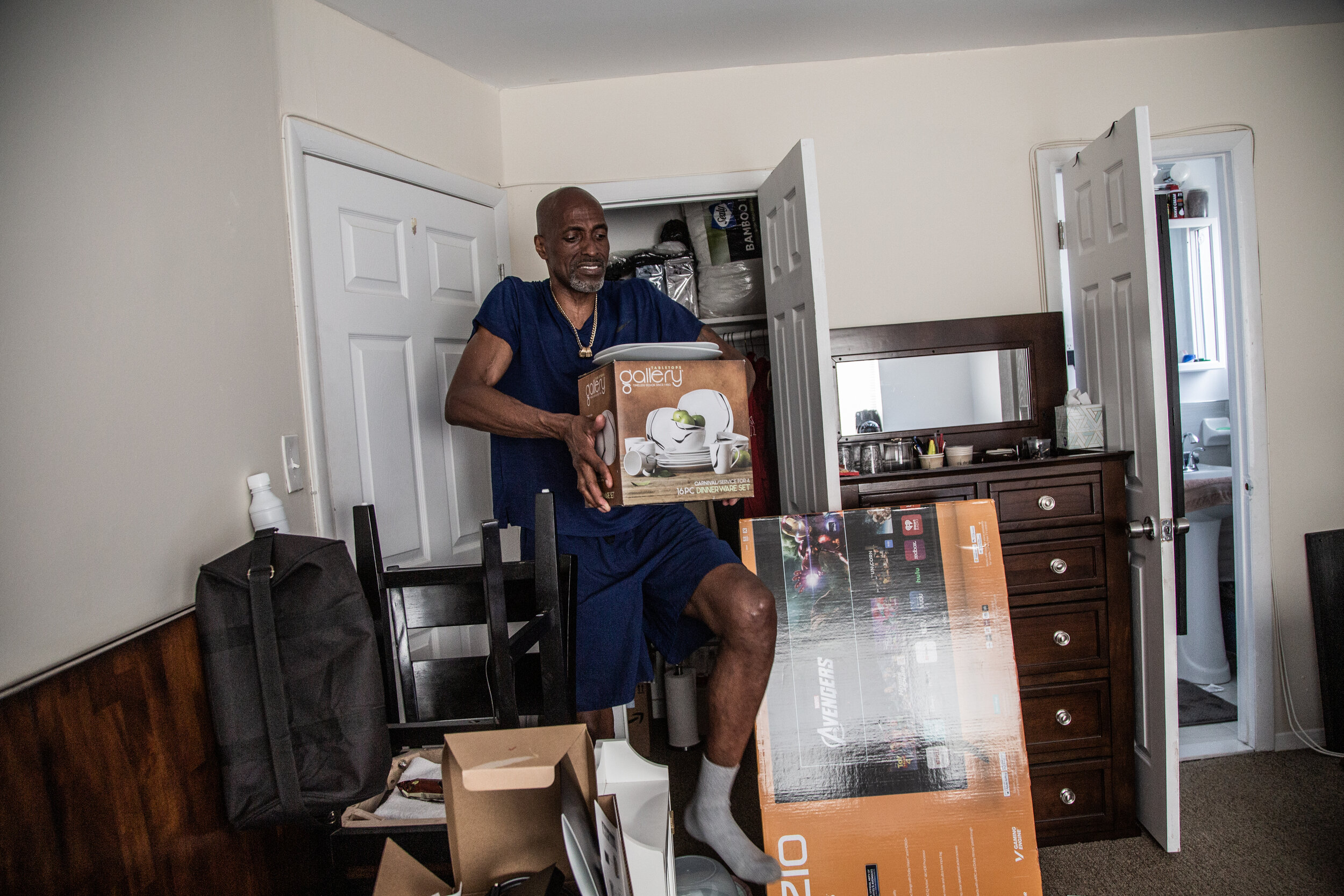  Kevin Mays carries his new cutlery inside his bedroom in The Bronx on May 19, 2021. 