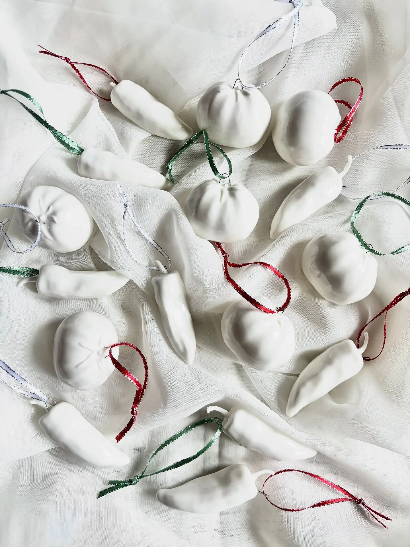 Garden ornaments! If you missed them last year, you can snag them at Warm &amp; Bright @artlingtonstudios or on my website. I made a plaster mold from a tomato and jalape&ntilde;o I grew in the garden and casted them in a very white porcelain - which