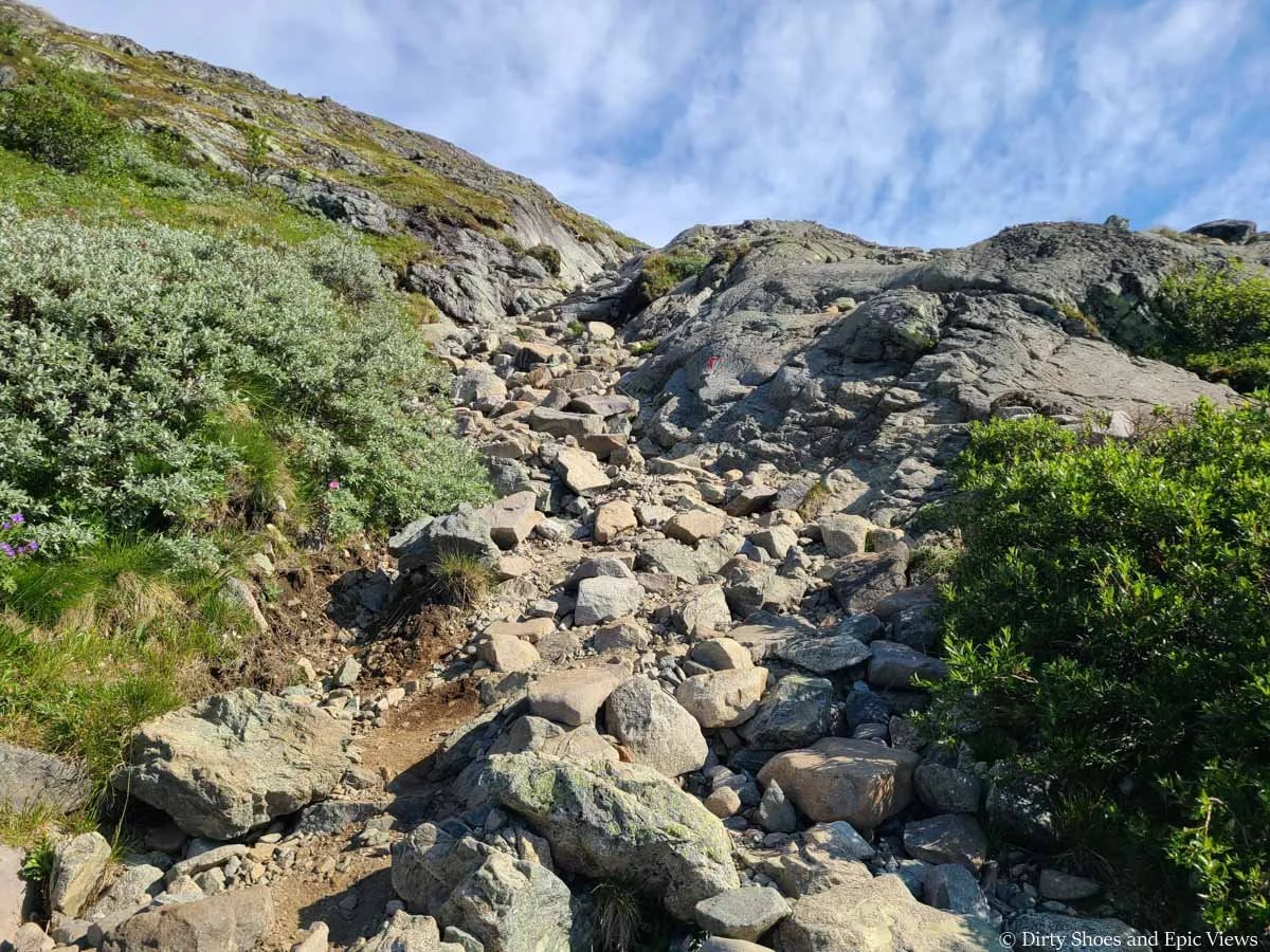 A rocky trail ascends a steep slope on the Besseggen Ridge trail in Norway