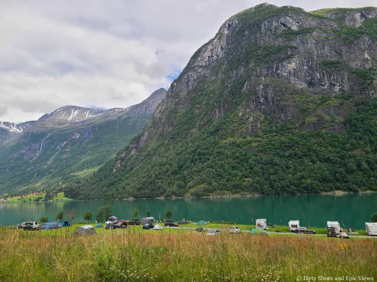 Campers line up along a blue lake near Briksdalsbreen in Norway
